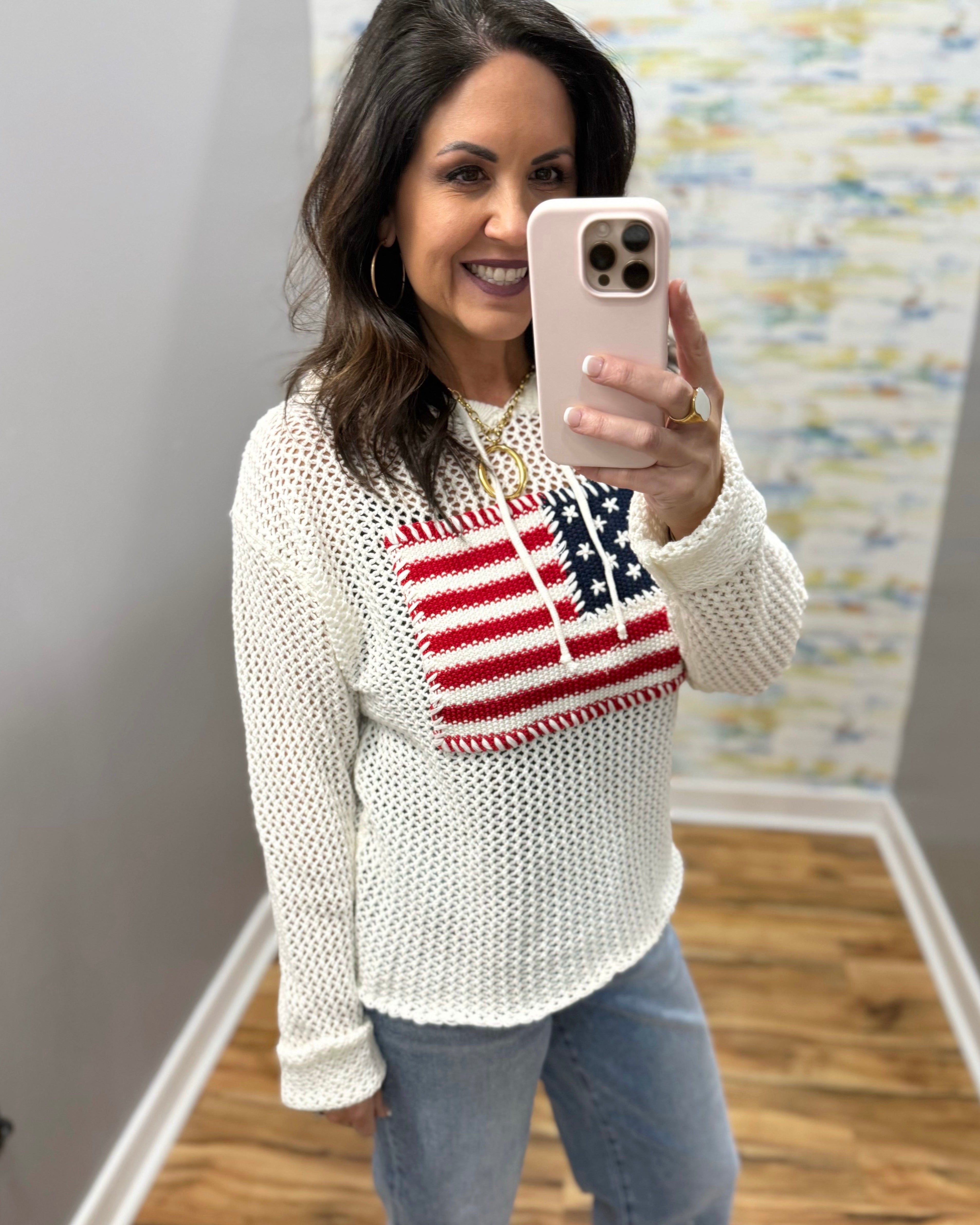 woman wearing american flag knit sweater in white