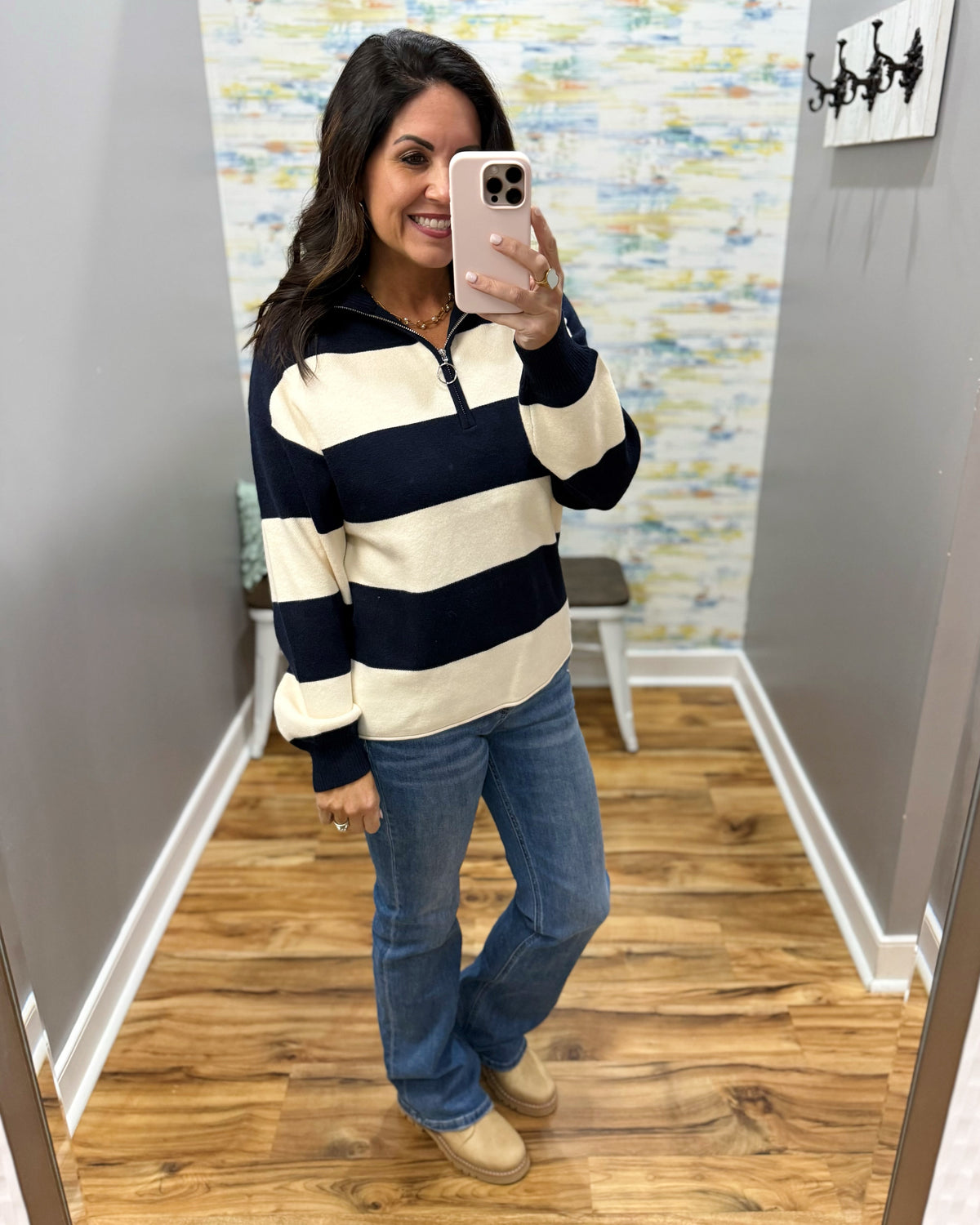 woman taking a selfie wearing a navy and white stripe long sleeve pullover with quarter front zipper.
