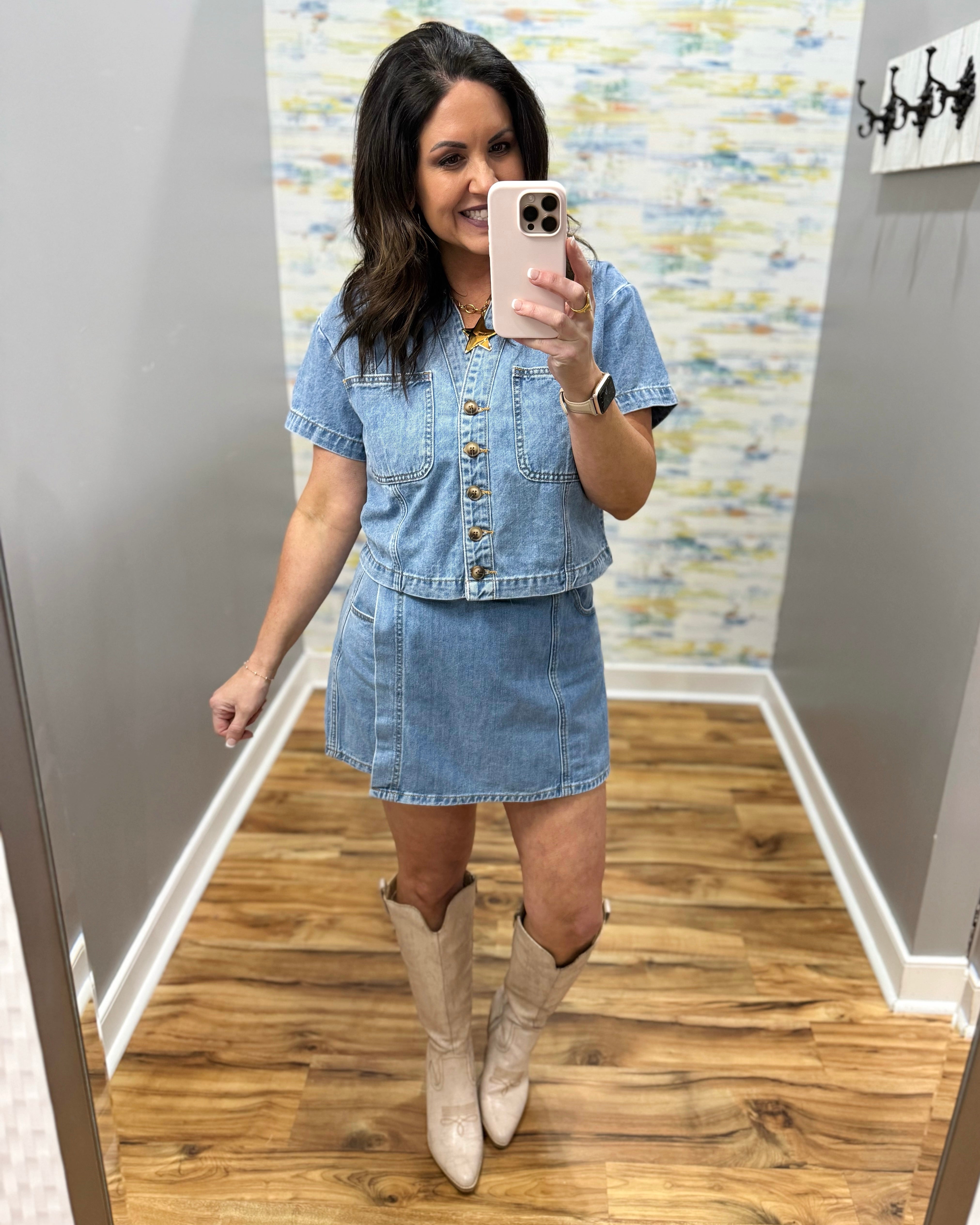woman wearing button up denim top