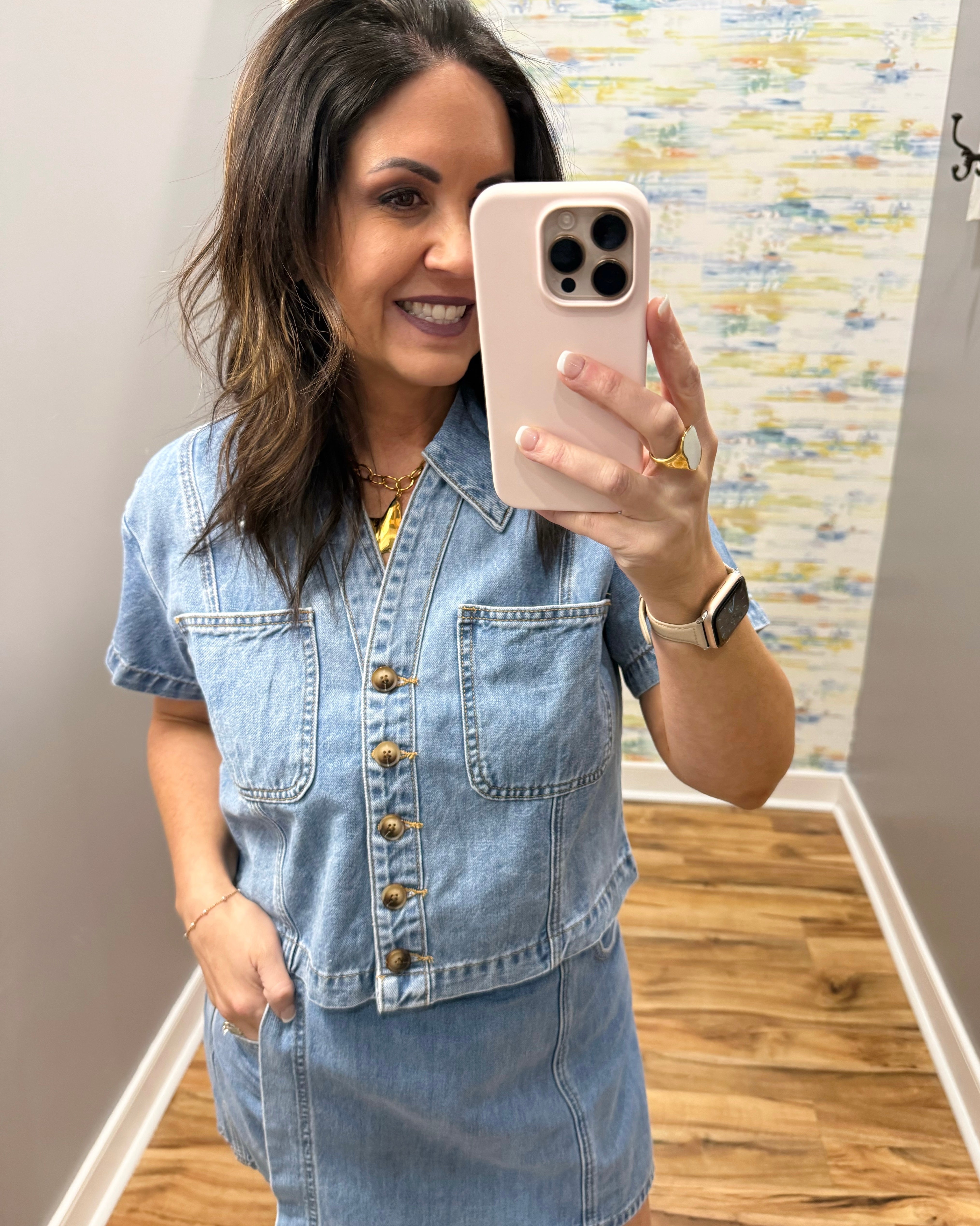 woman wearing button up denim top