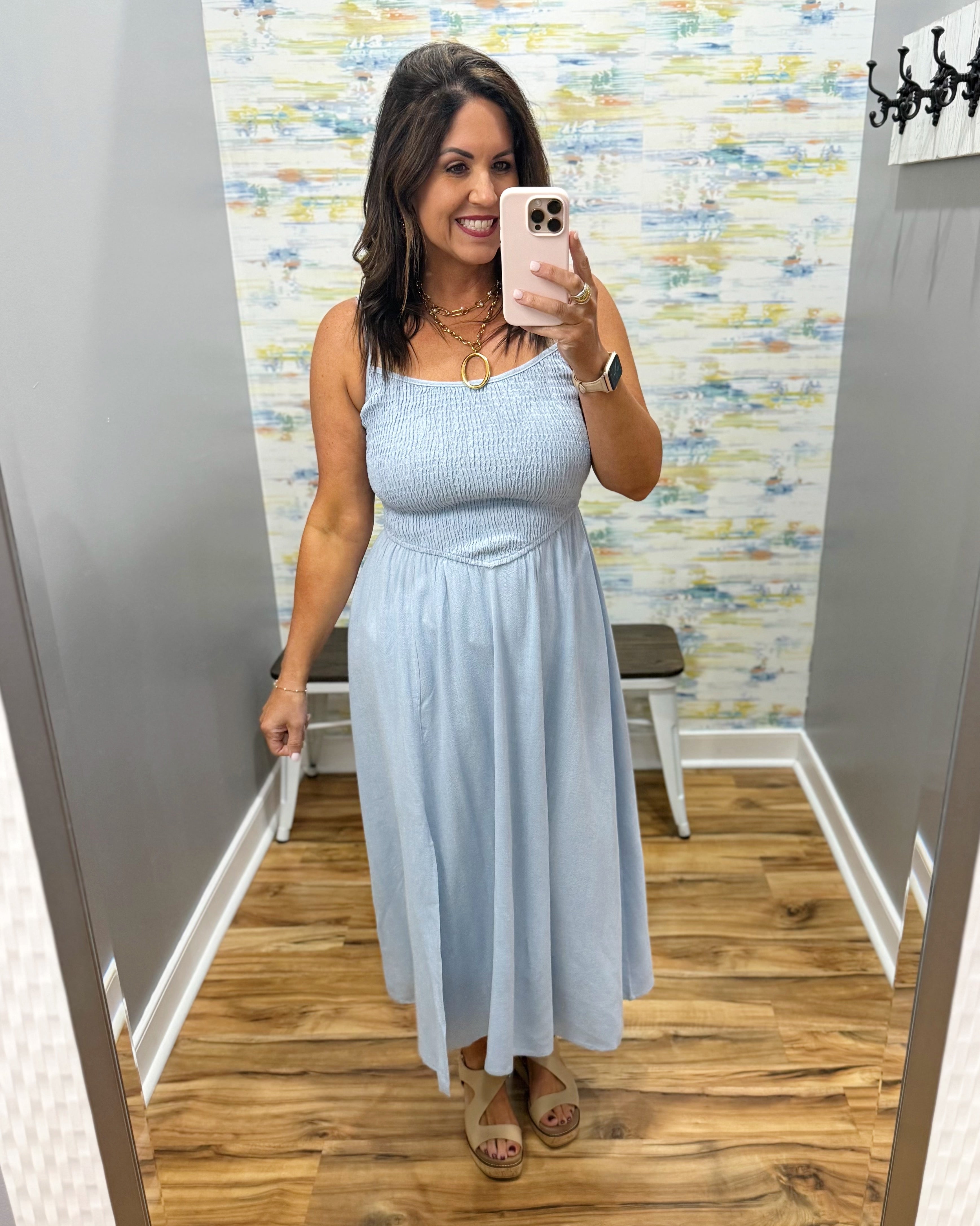 woman wearing a light blue denim maxi dress.