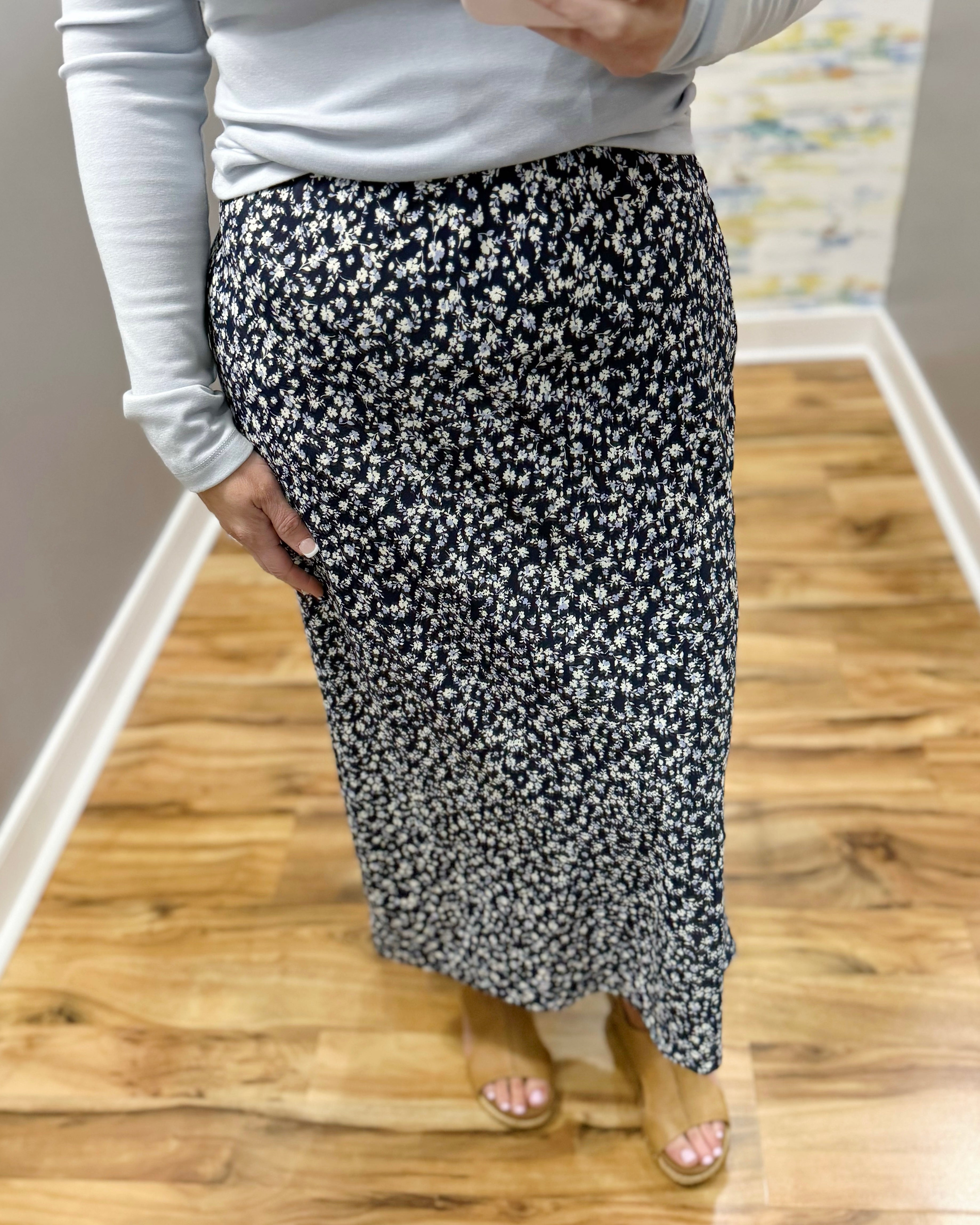 woman wearing navy blue floral midi skirt