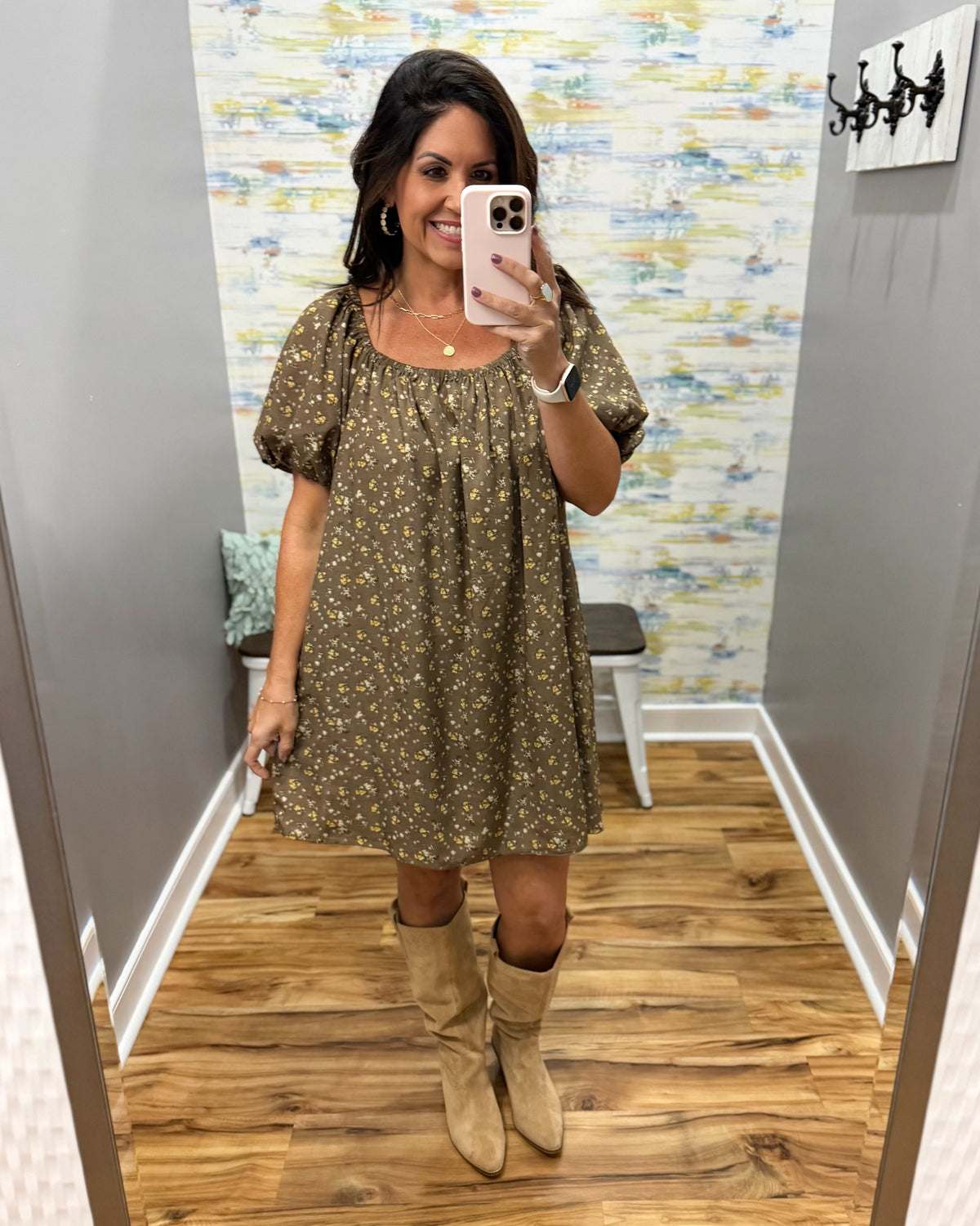 woman taking a selfie wearing a hazelnut mini dress features a beautiful floral print with statement puff sleeves