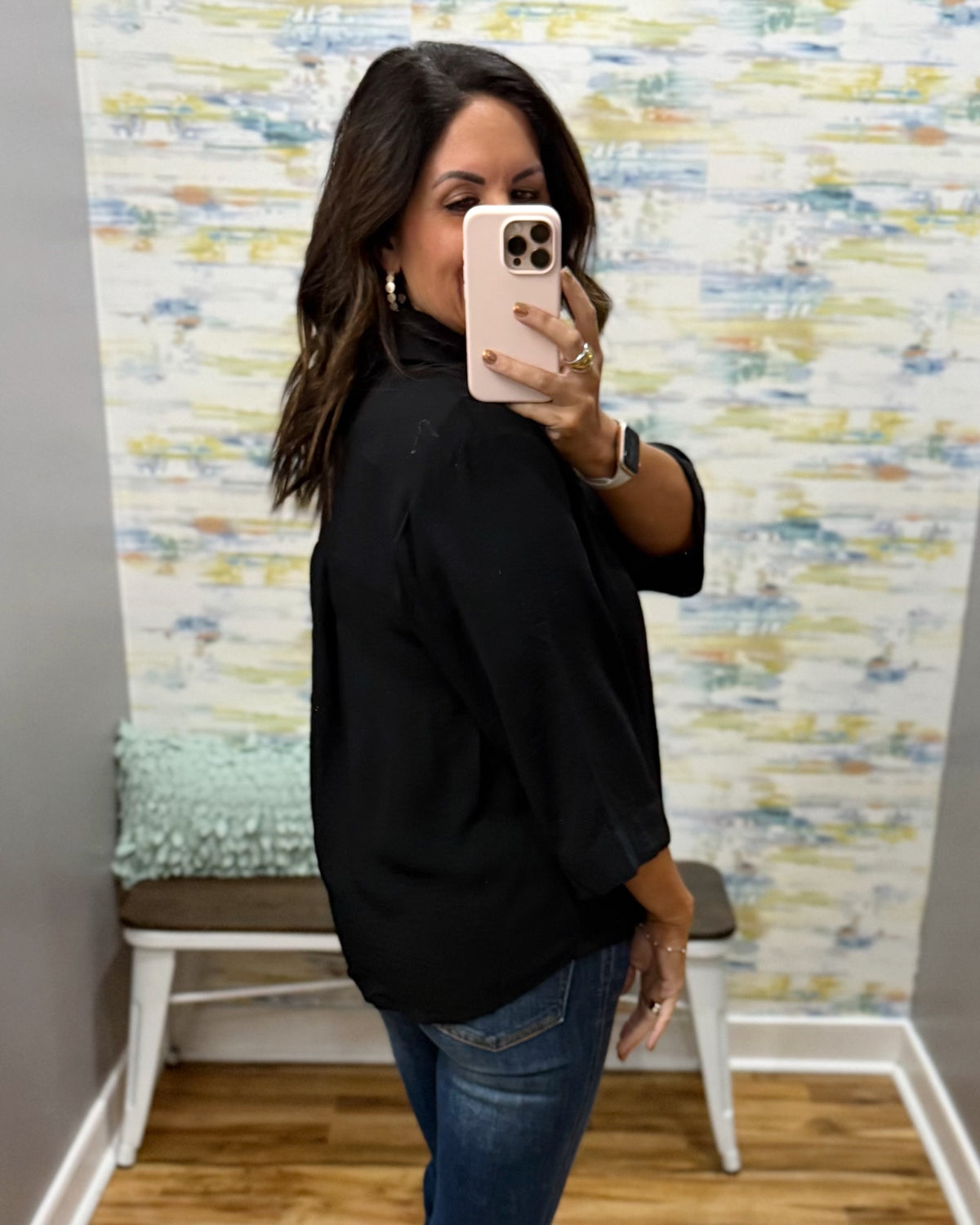 woman wearing a black 3/4 sleeve flowy top.