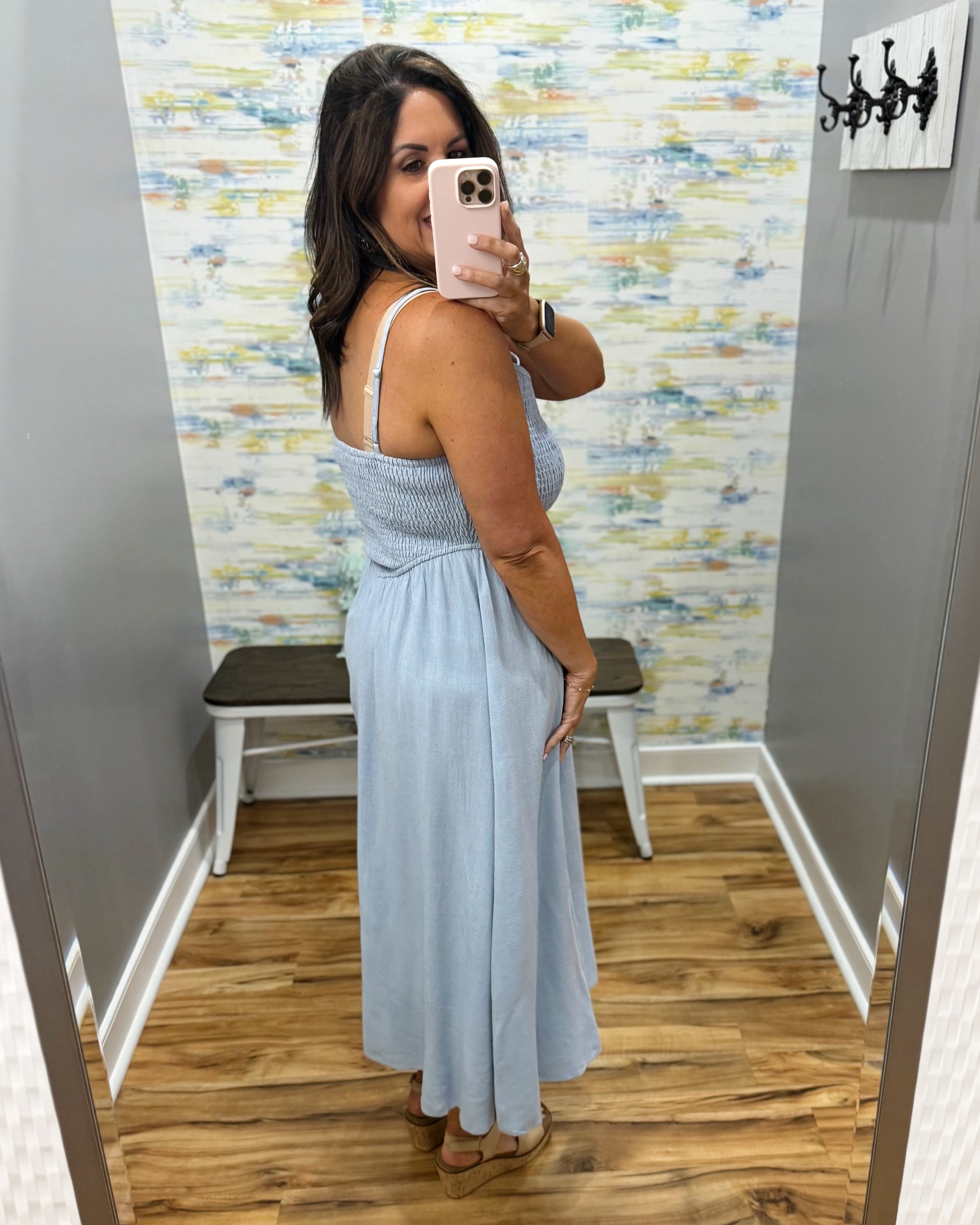 woman wearing a light blue denim maxi dress.