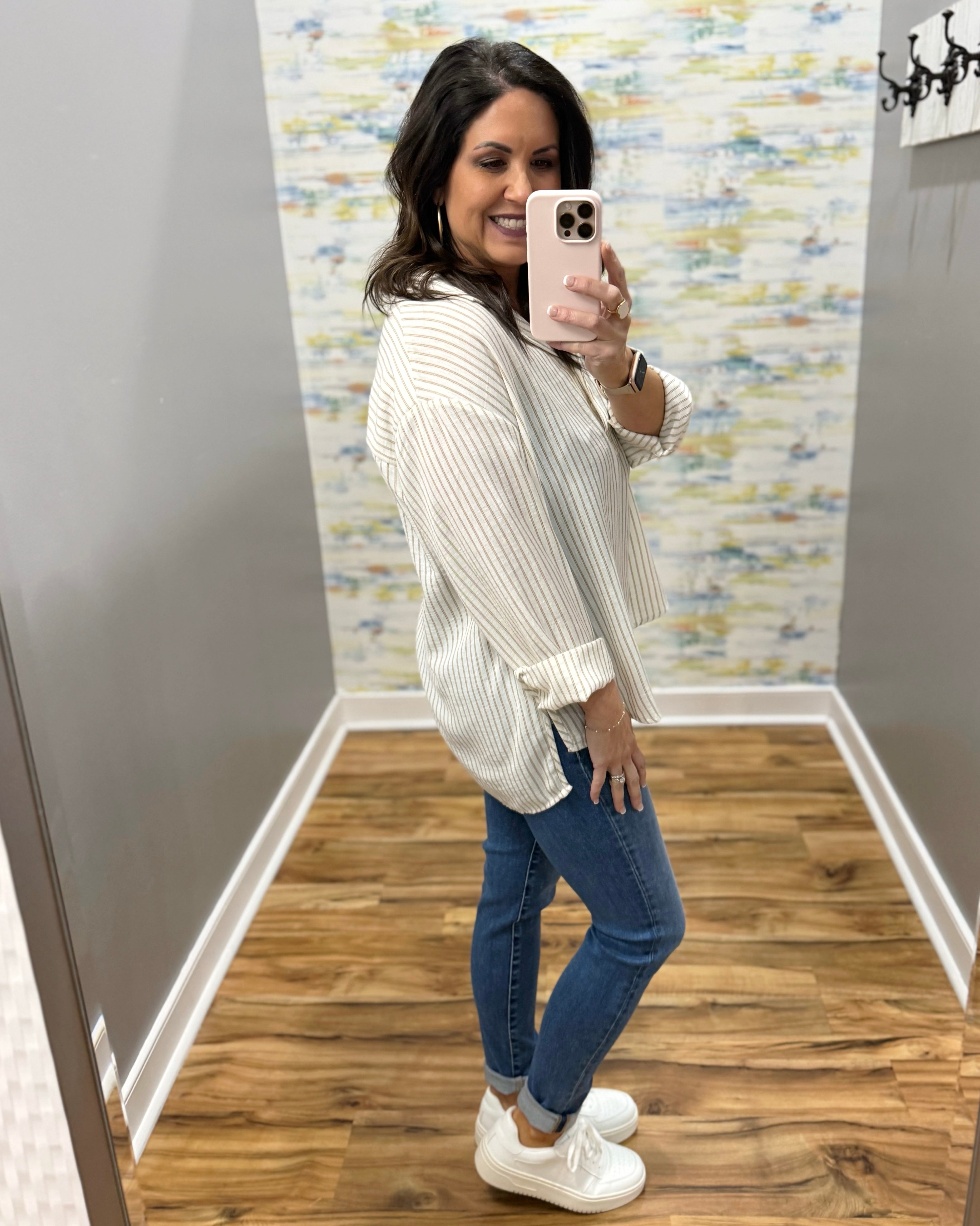 woman wearing a striped blouse in mocha and white
