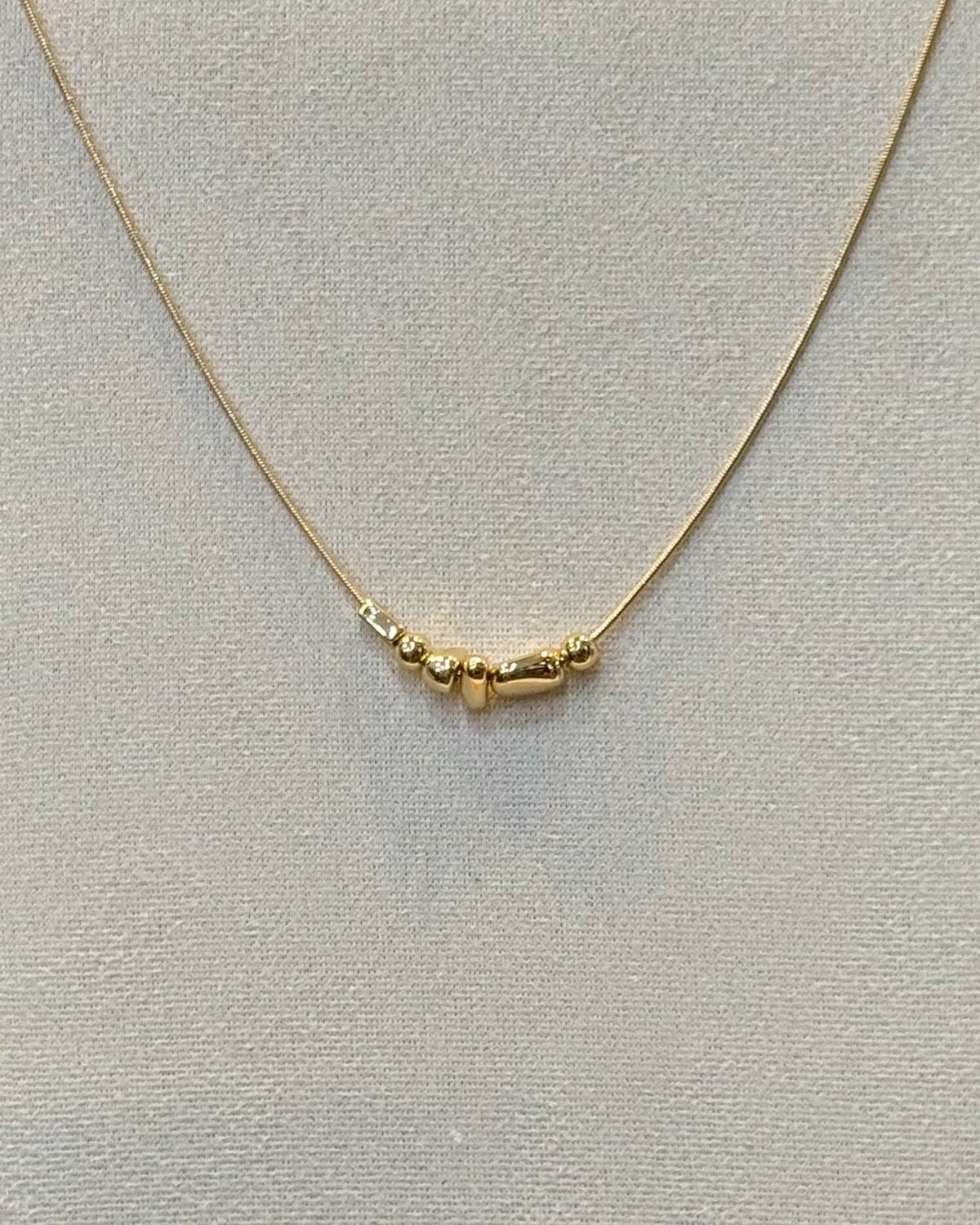 dainty gold nugget necklace.
