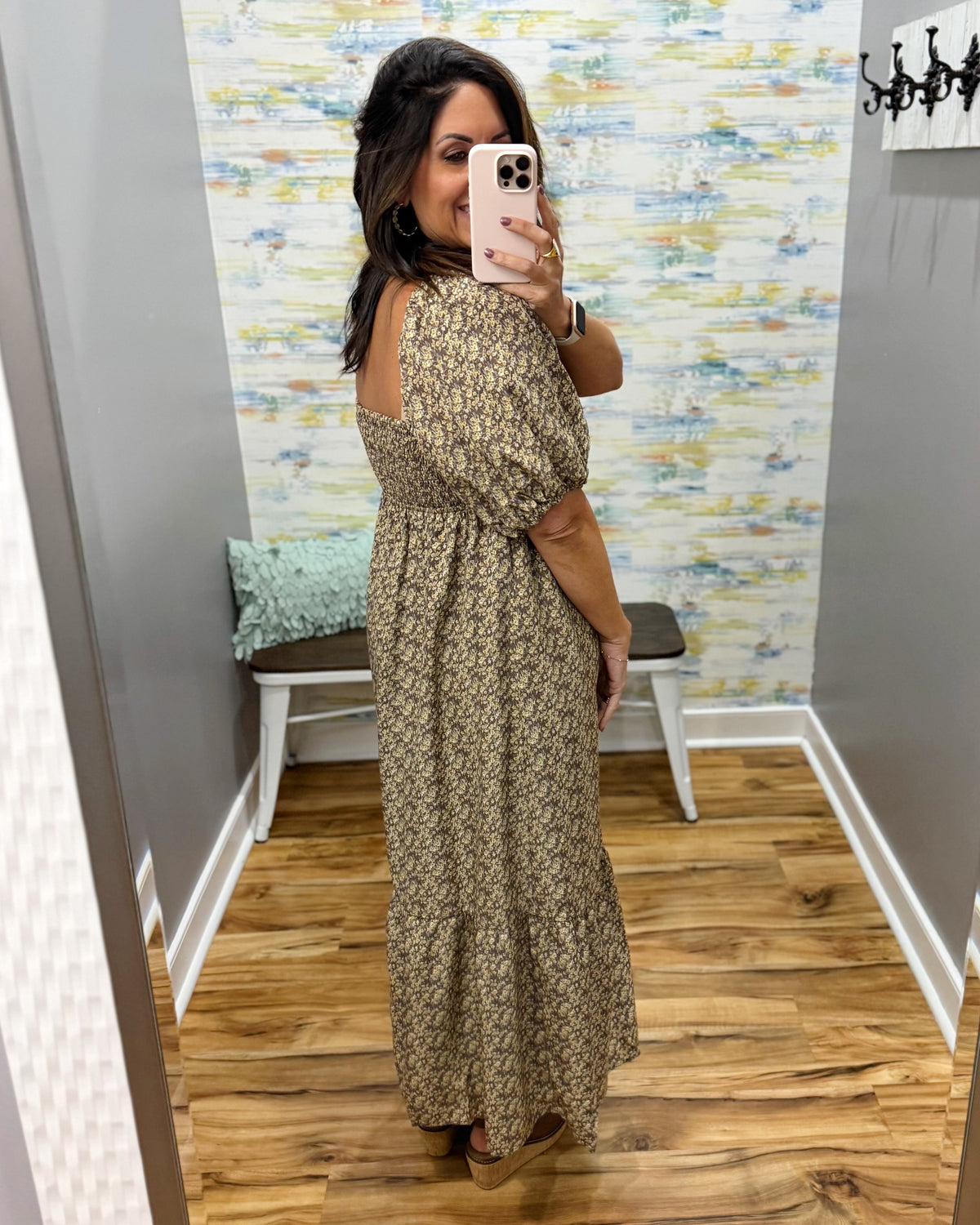 woman taking a selfie wearing a floral midi dress features a pretty square neckline and smocked detailing for a comfortable, figure-flattering fit. Decorative non-functional buttons add a classic touch, while the midi length gives it an easy, polished silhouette.