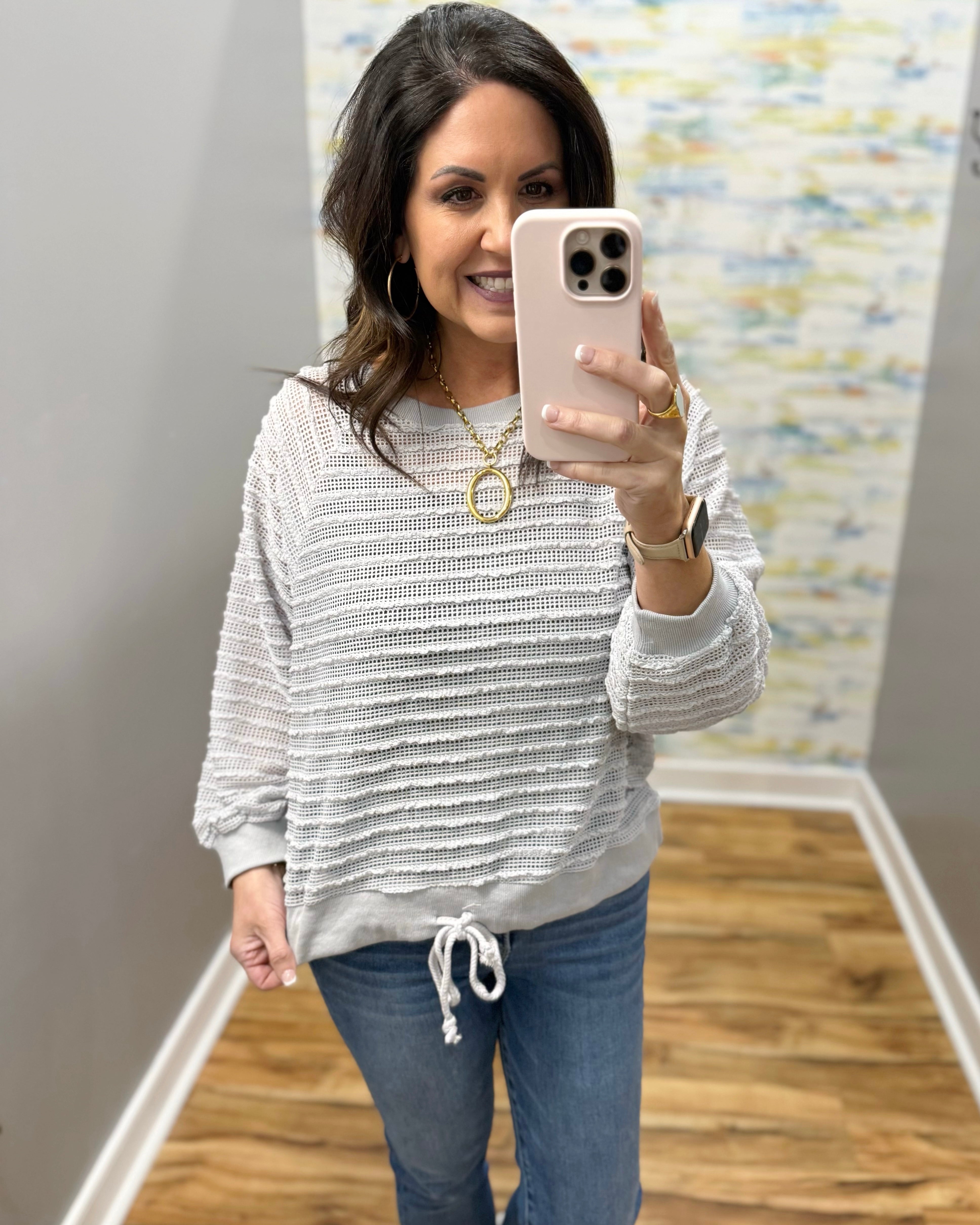 woman wearing a lightweight sweater top in stone color