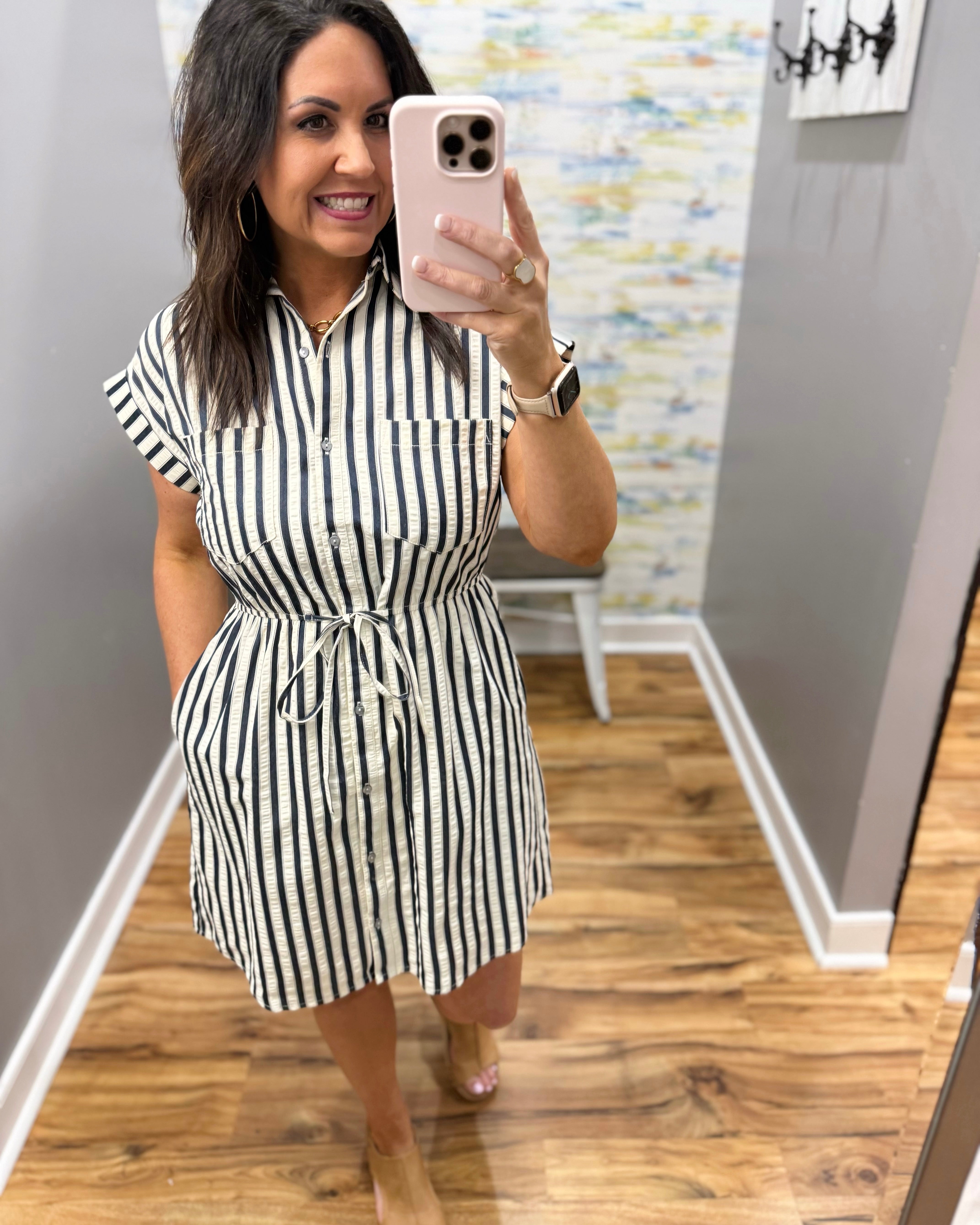 Woman wearing a black and white striped dress.