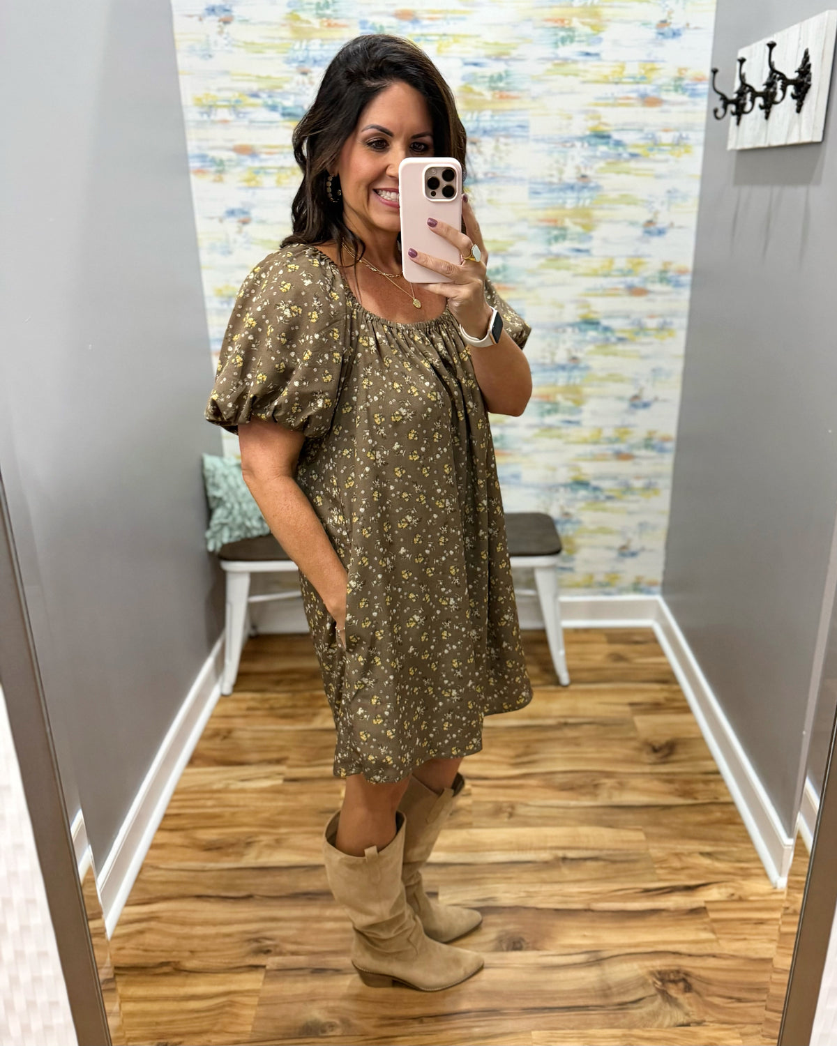 woman taking a selfie wearing a hazelnut mini dress features a beautiful floral print with statement puff sleeves