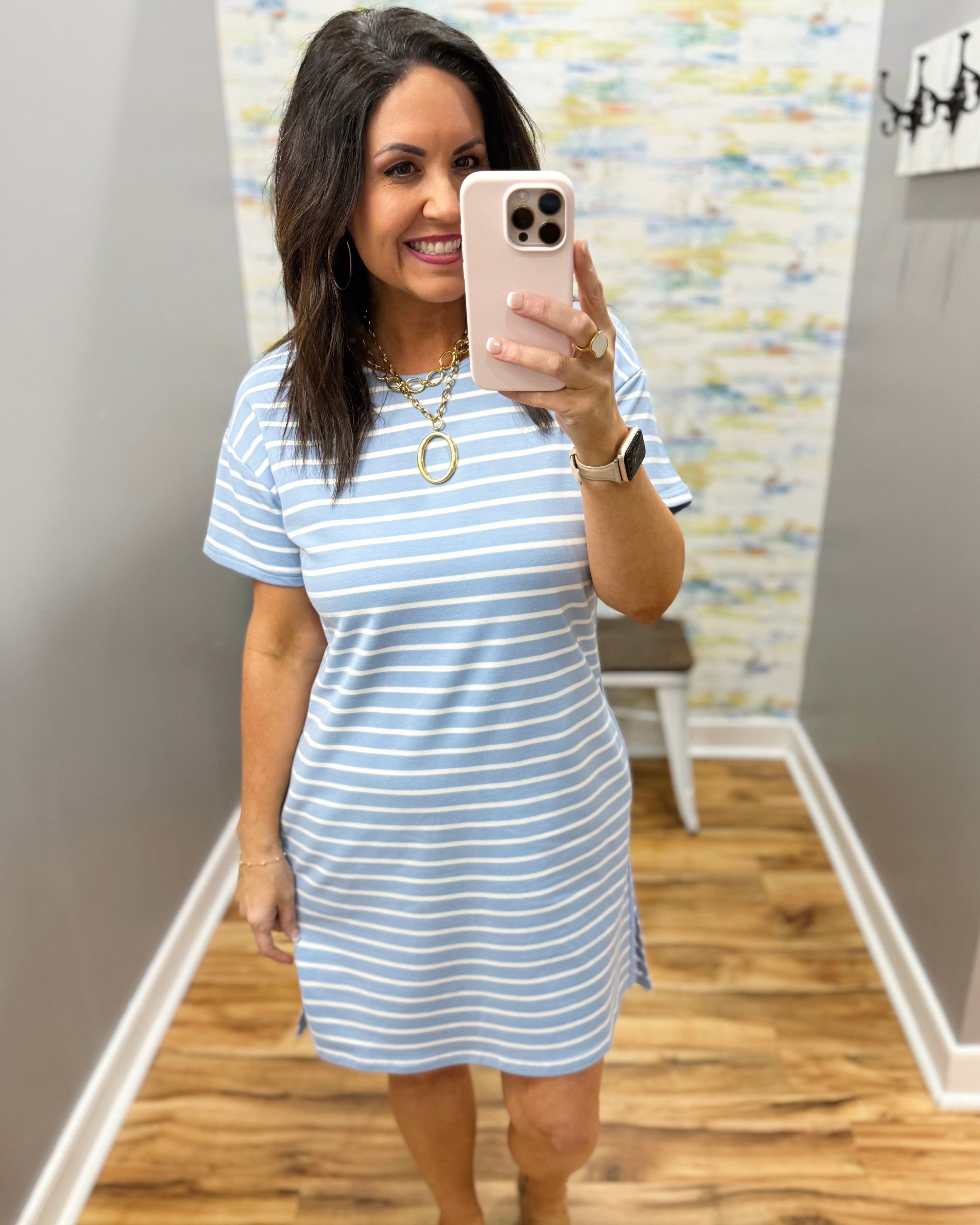 Woman wearing a blue and white striped dress.
