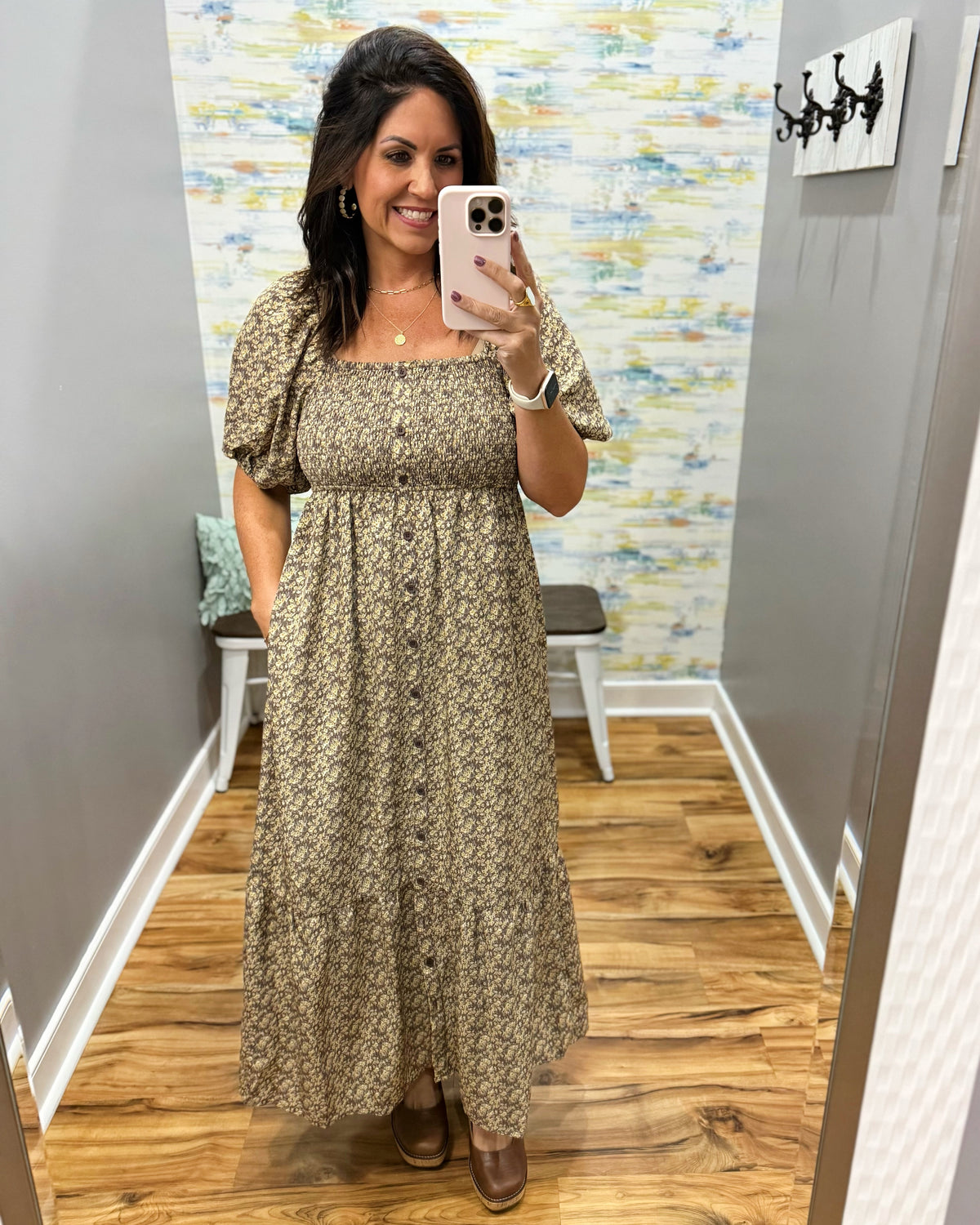 woman taking a selfie wearing a floral midi dress features a pretty square neckline and smocked detailing for a comfortable, figure-flattering fit. Decorative non-functional buttons add a classic touch, while the midi length gives it an easy, polished silhouette.