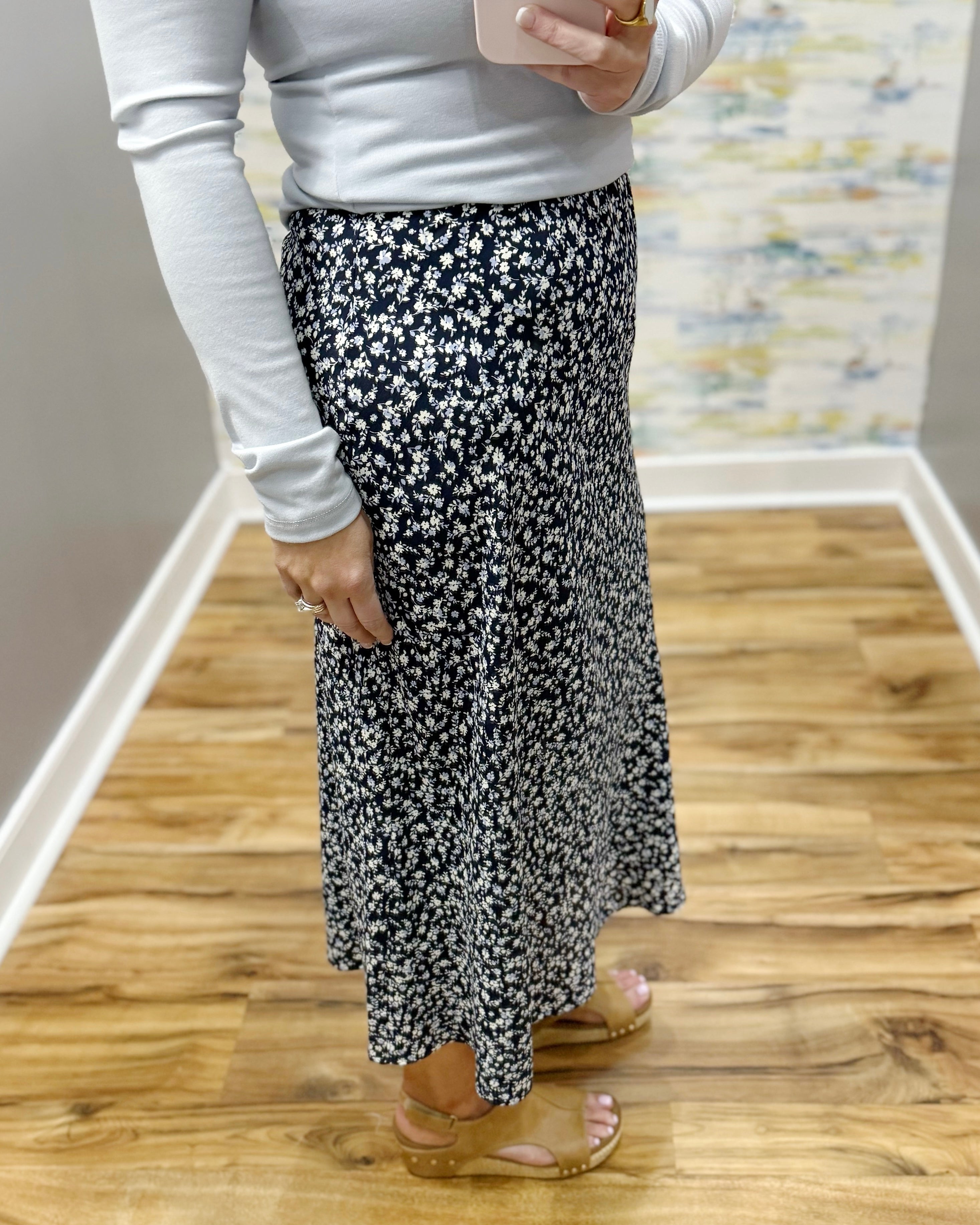 woman wearing navy blue floral midi skirt