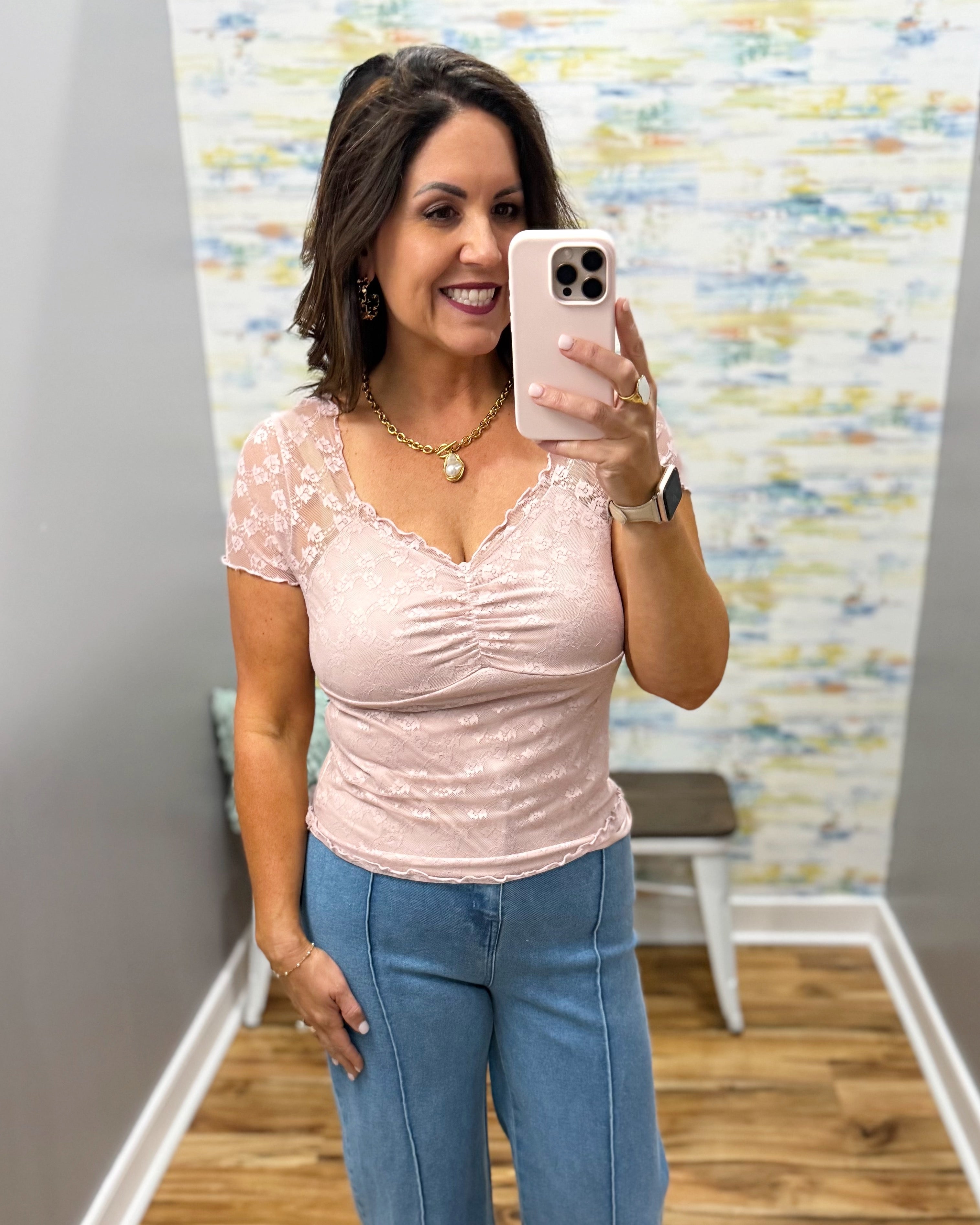 woman wearing a lilac colored top with wide leg pants.