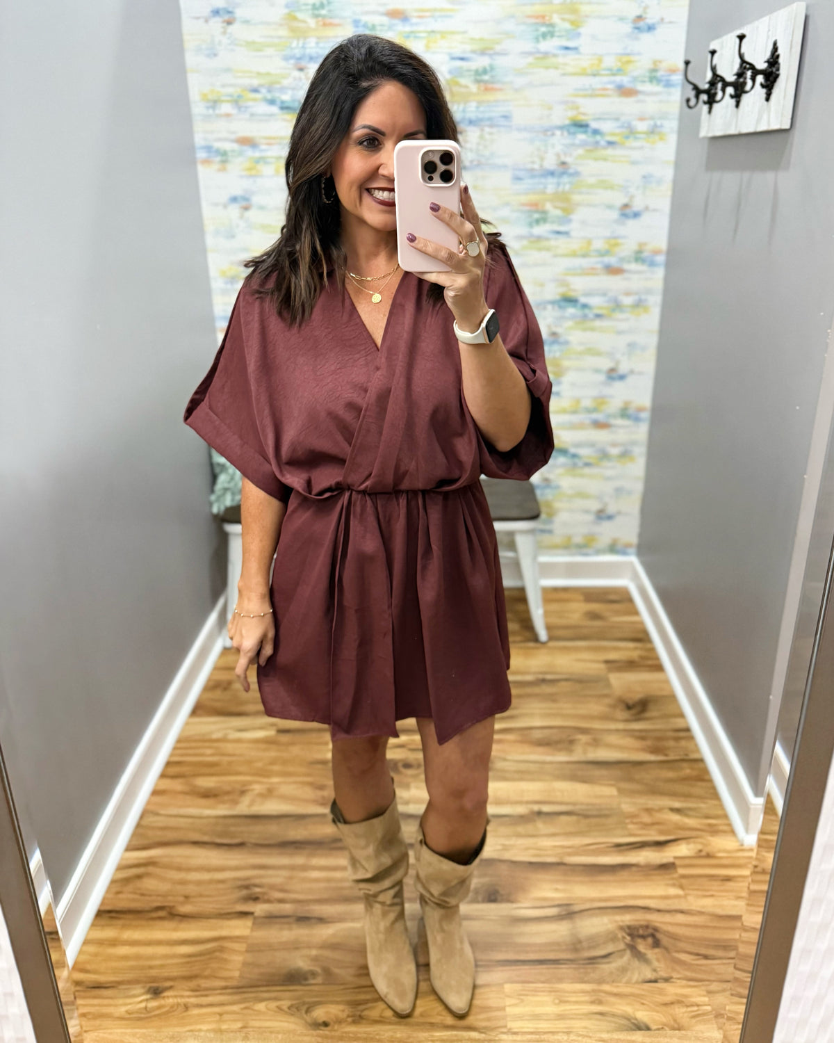 woman taking a selfie wearing a burgundy wrap dress featuring a V-neckline, cinched waist, and flowy short sleeves for a feminine silhouette.