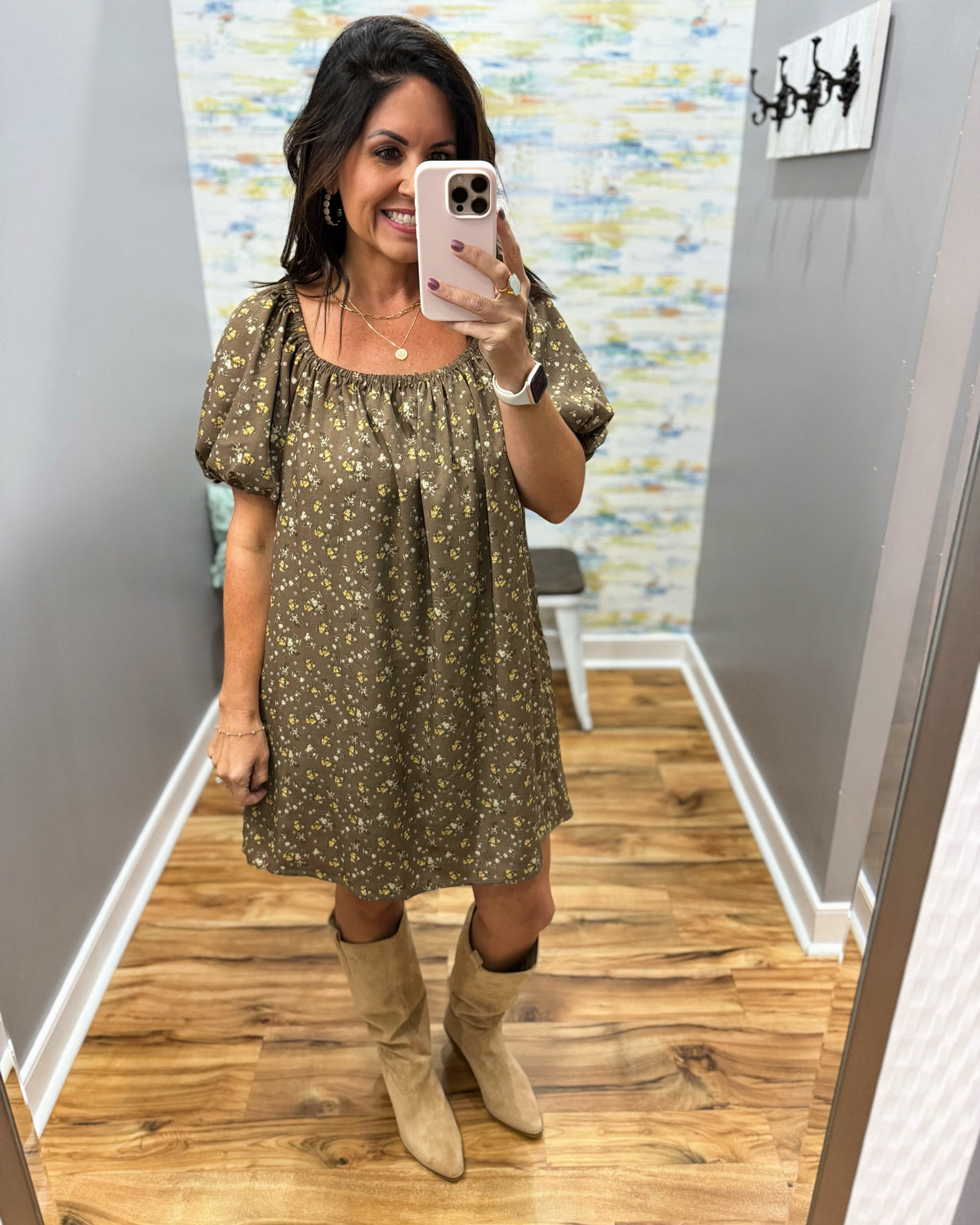 woman taking a selfie wearing a hazelnut mini dress features a beautiful floral print with statement puff sleeves