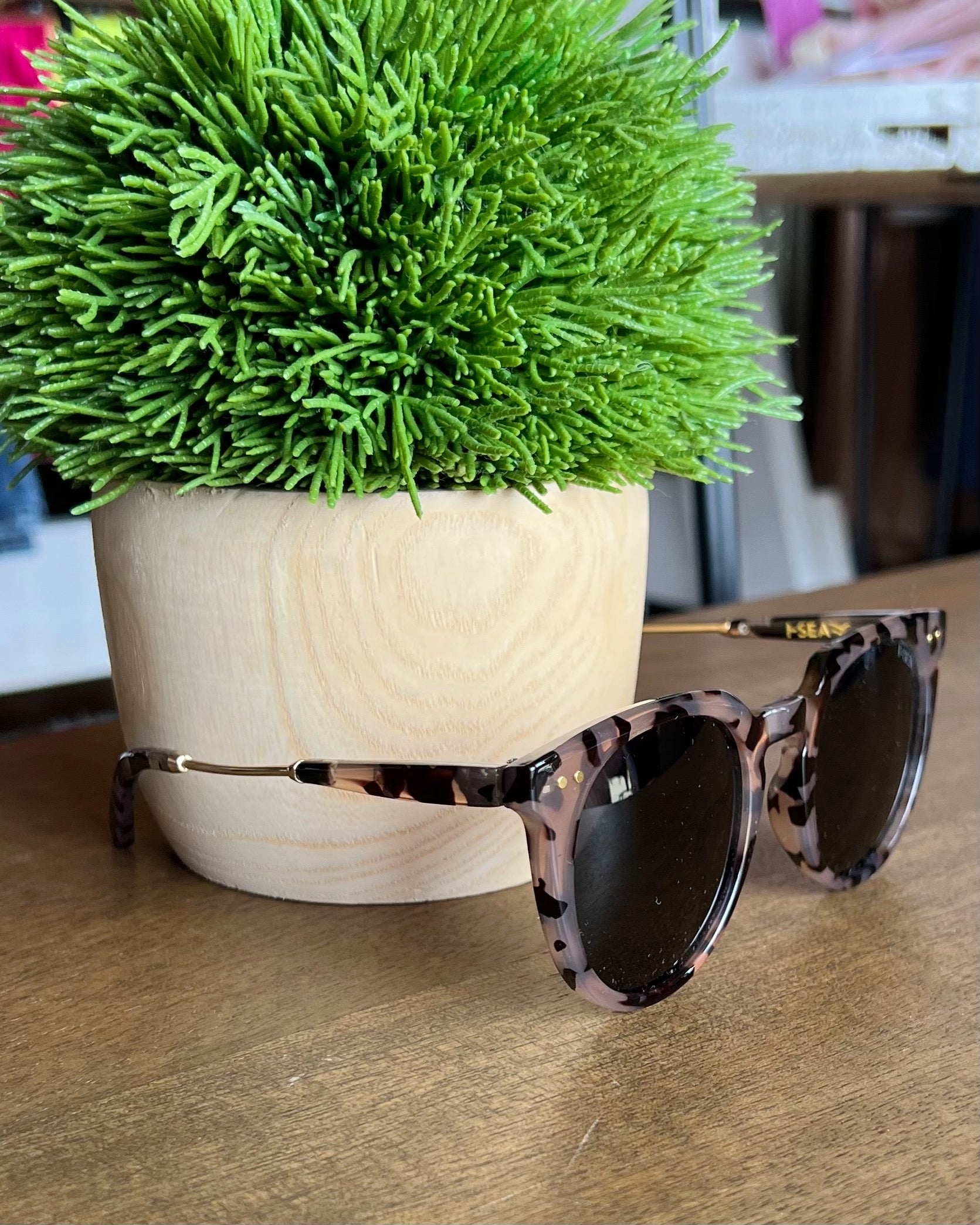 i-sea ella sunglasses sitting on table.