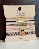 Set of hair ties and bracelets on a 'Kilani' branded card with leopard print and gold accents.