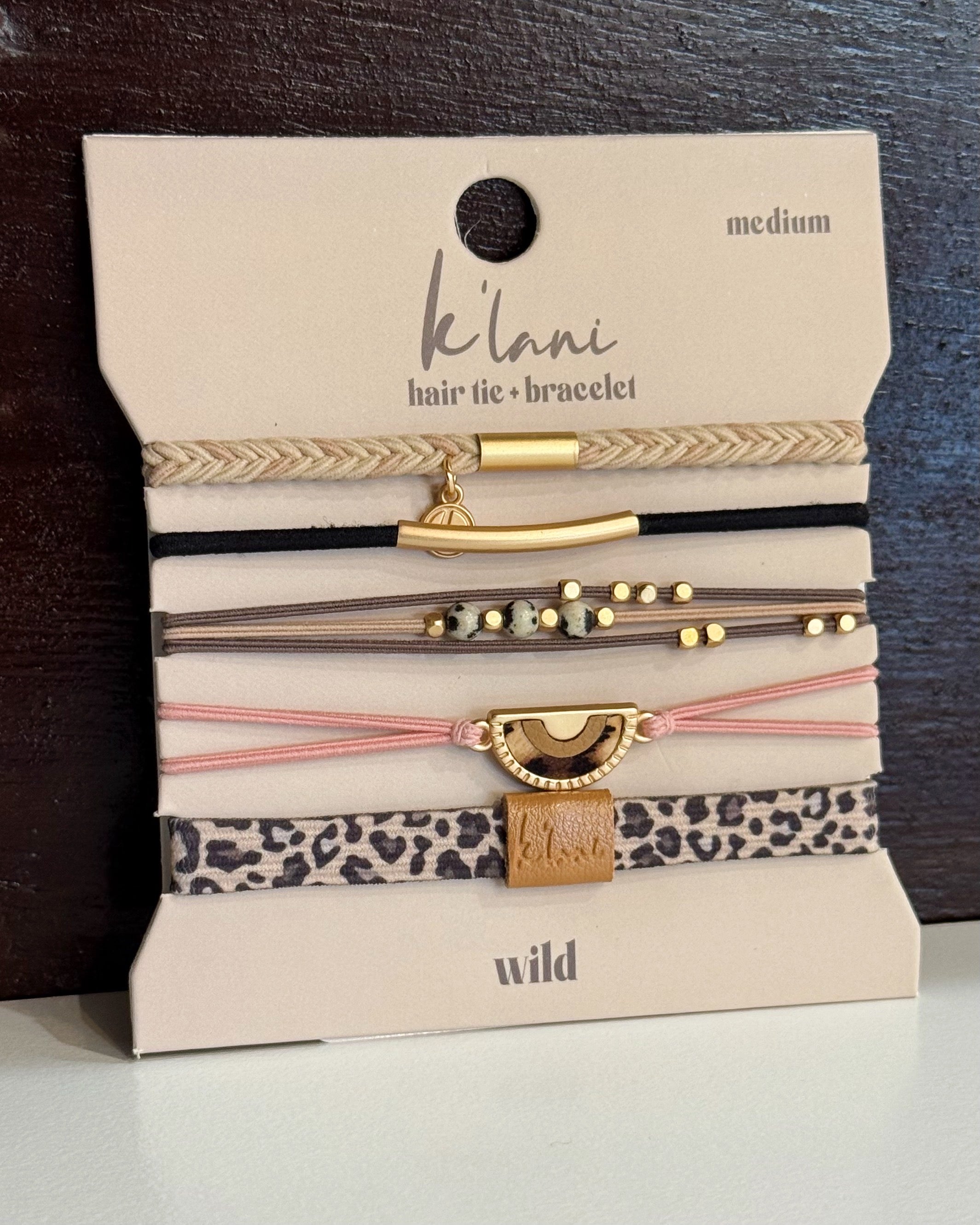 Set of hair ties and bracelets on a 'Kilani' branded card with leopard print and gold accents.