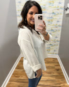 woman wearing a stripe blouse in mocha and white
