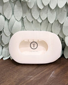 white hair claw with 'Teleties' branding on a textured surface