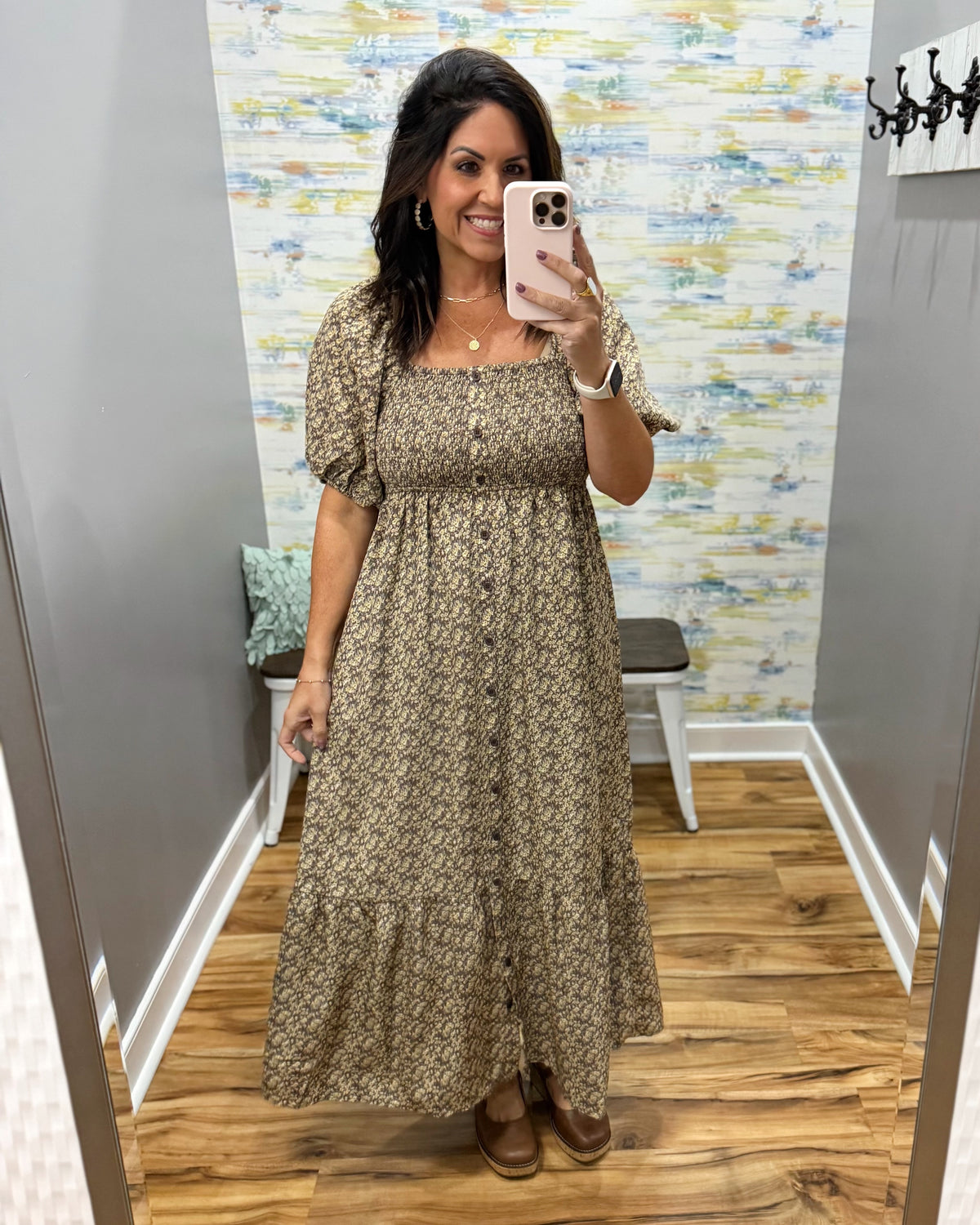 woman taking a selfie wearing a floral midi dress features a pretty square neckline and smocked detailing for a comfortable, figure-flattering fit. Decorative non-functional buttons add a classic touch, while the midi length gives it an easy, polished silhouette.