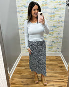 woman wearing navy floral midi skirt and long sleeve baby blue top