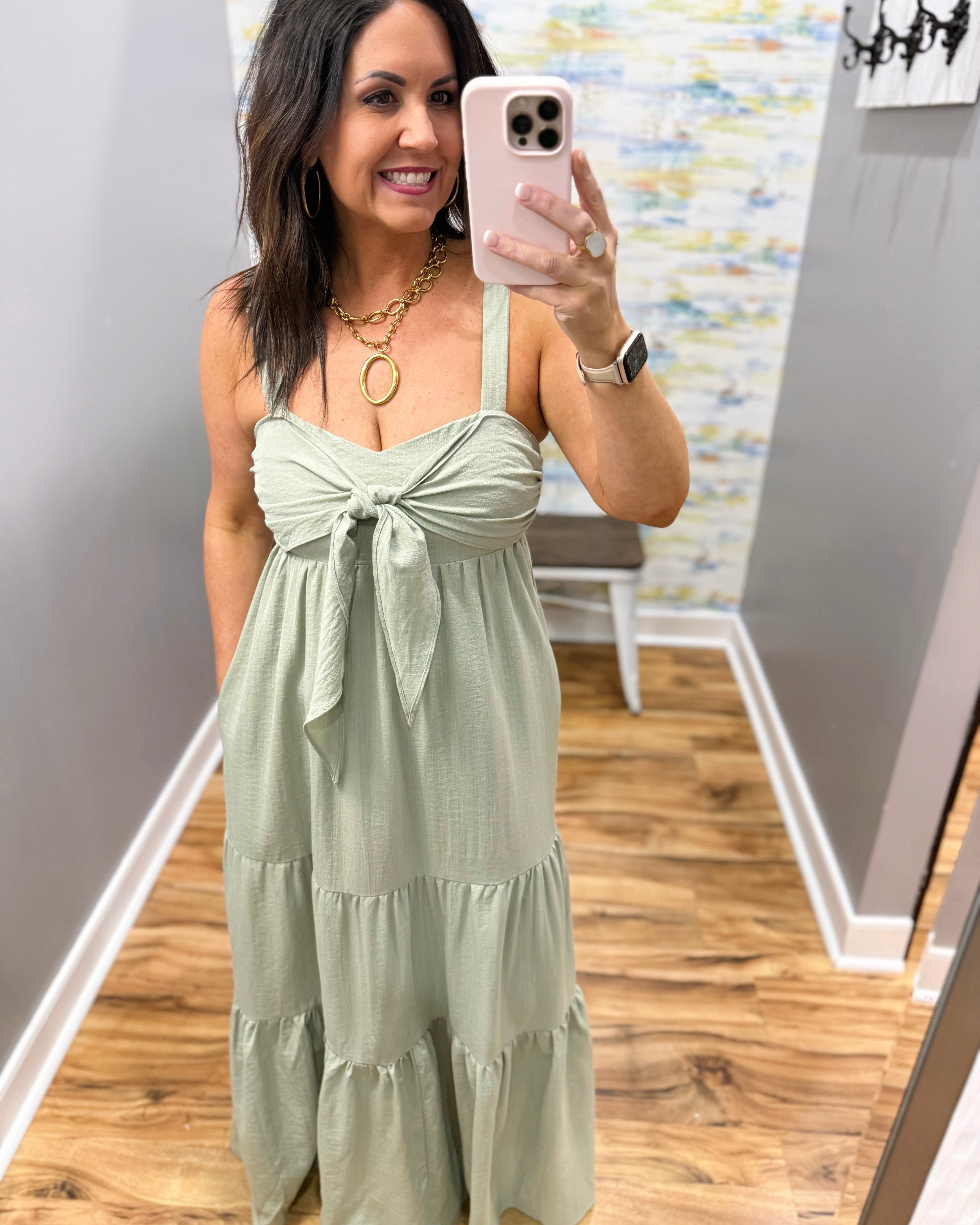 Woman wearing a light green dress in a store.
