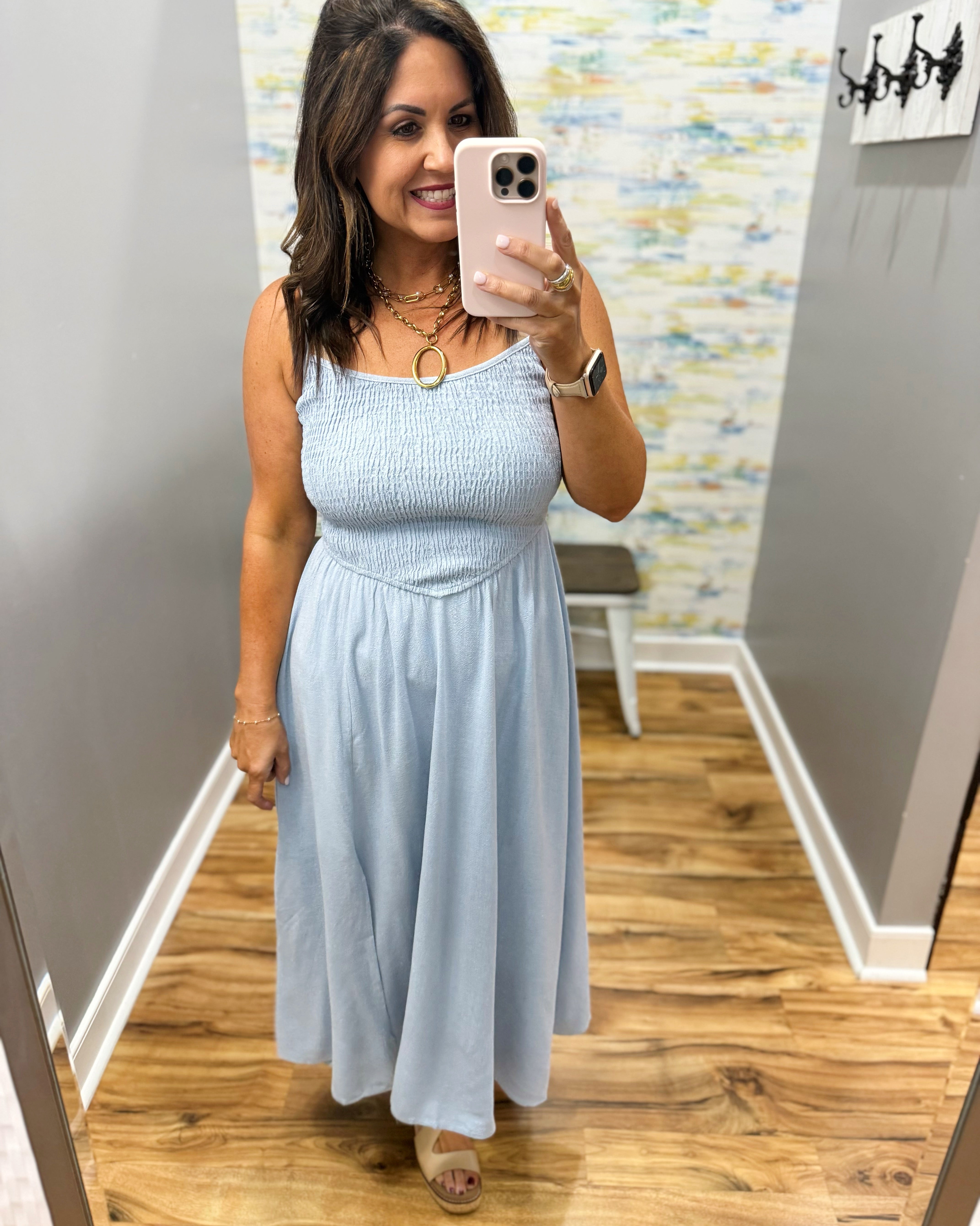 woman wearing a light blue denim maxi dress.
