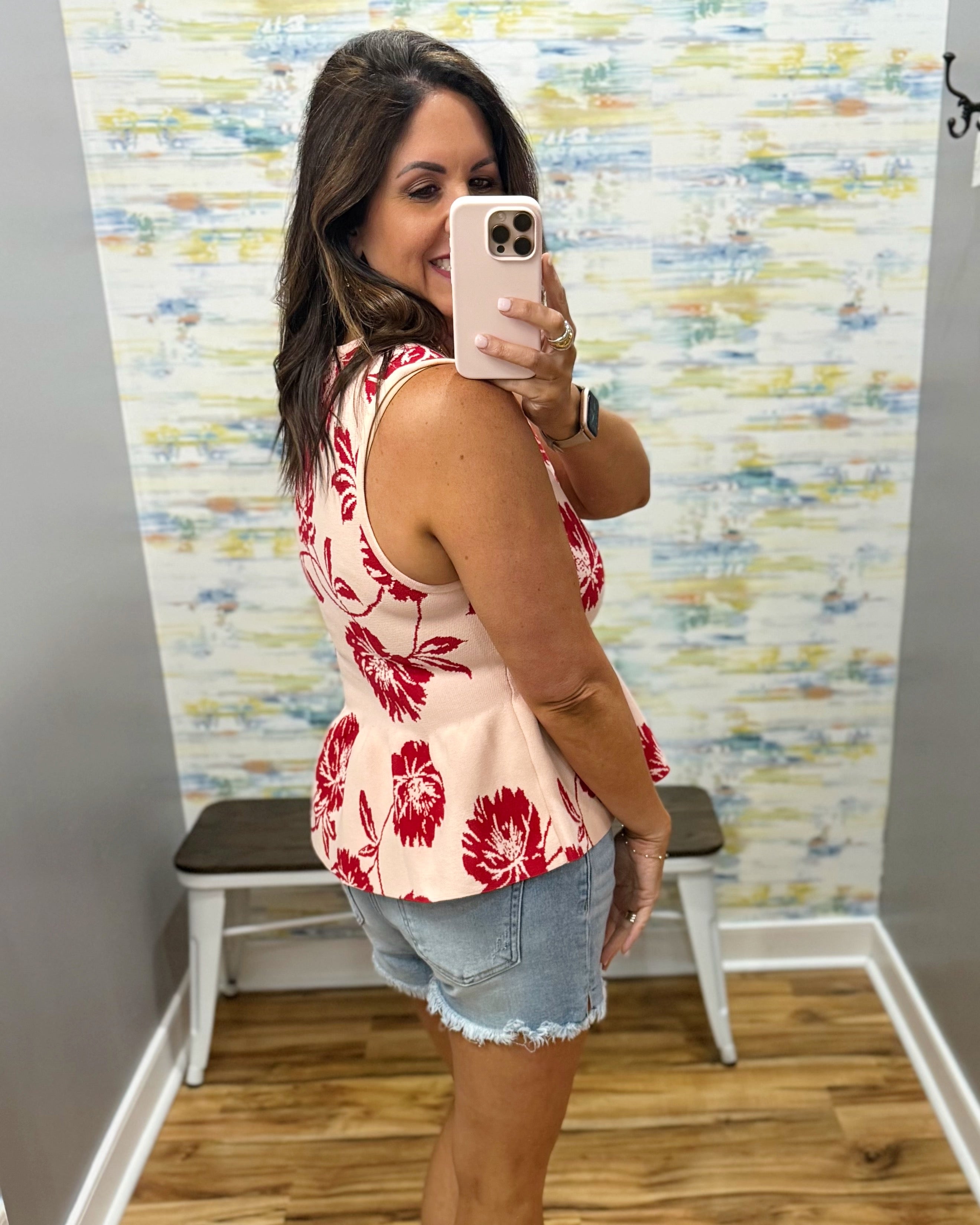 woman wearing a floral sweater tank. 