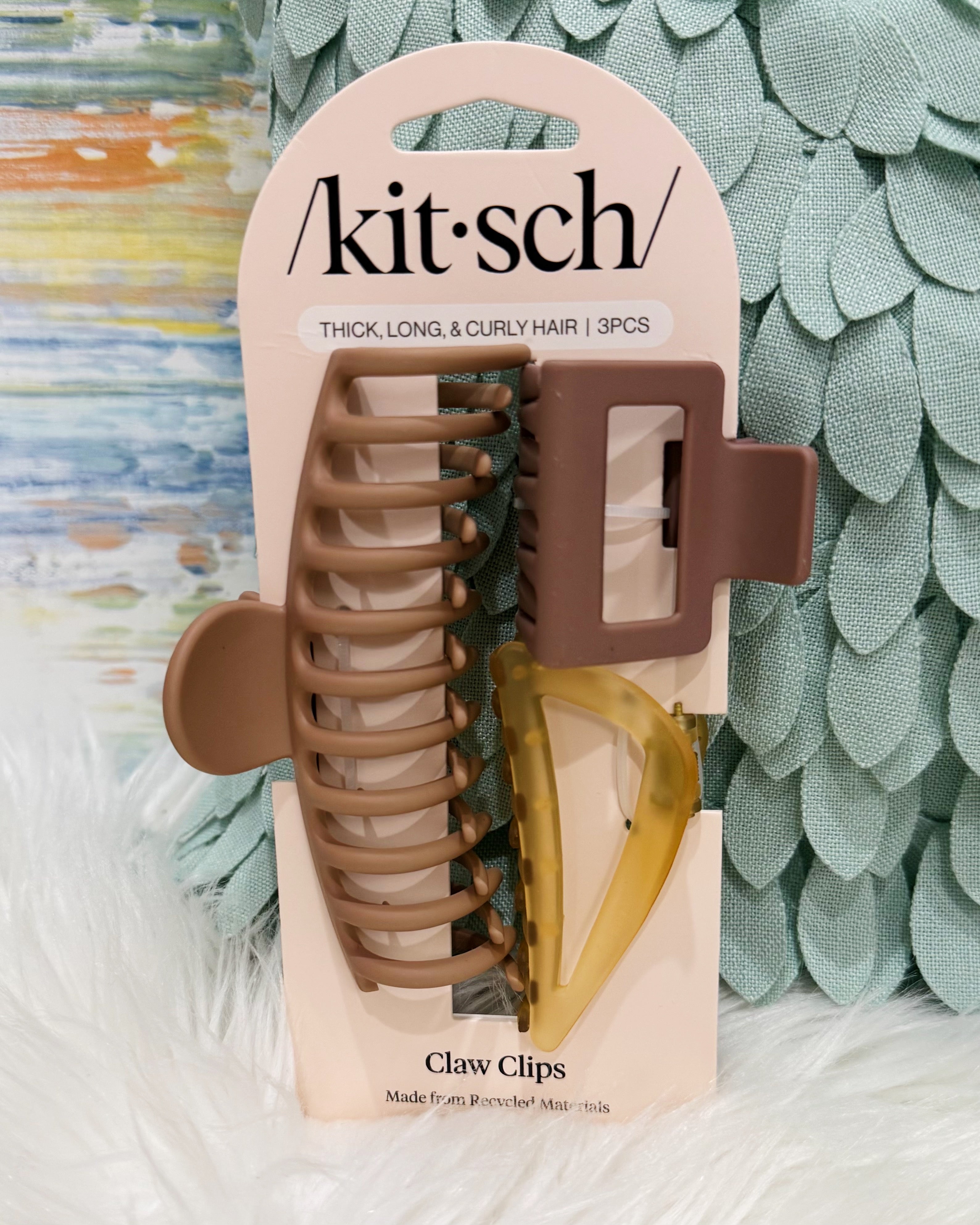 Kit Sch claw clips in a 3-piece set, packaged on a beige card. The set includes a large taupe-brown claw clip, a medium brown claw clip, and a translucent amber-yellow claw clip.