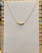 dainty gold nugget necklace.