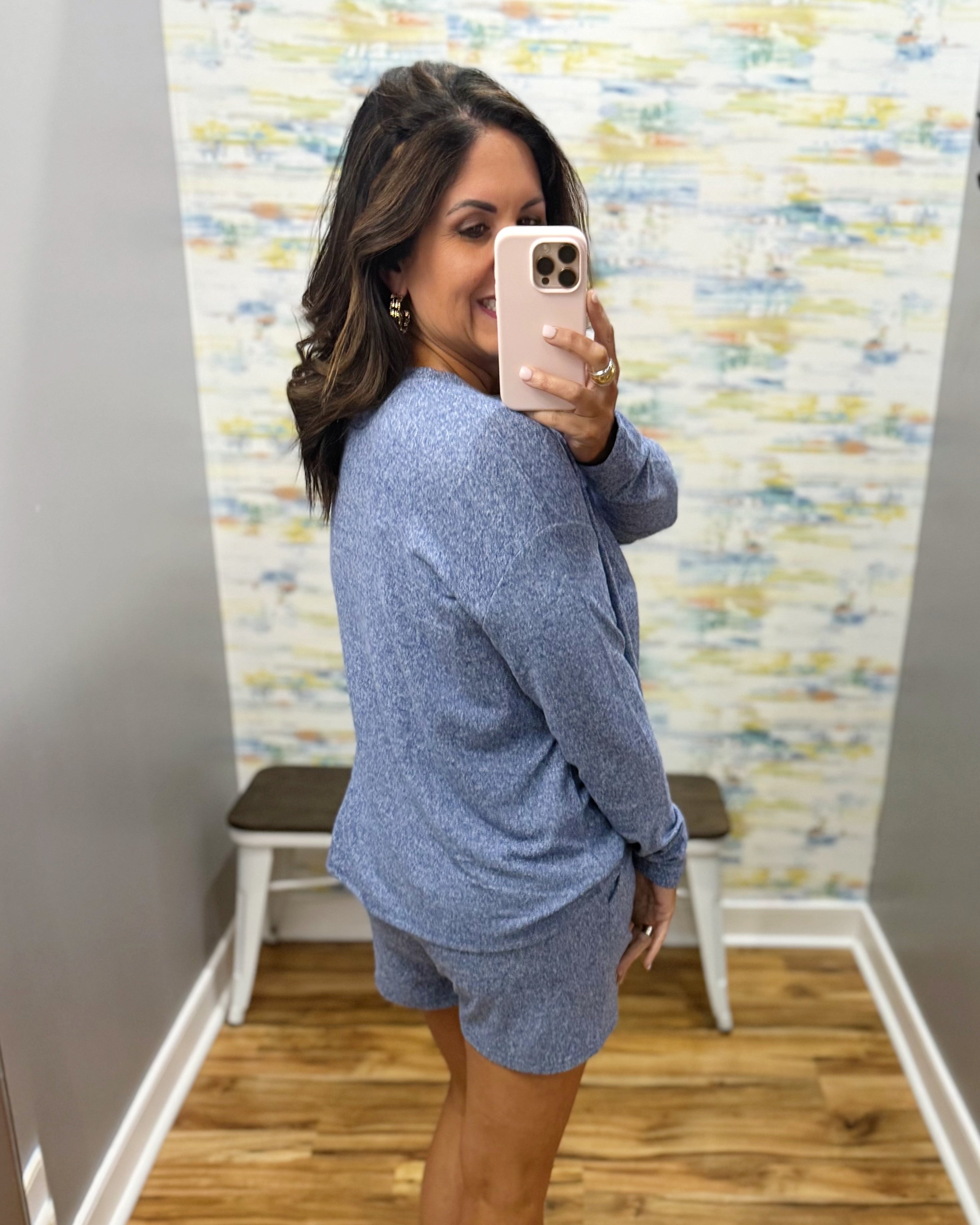 woman wearing light navy lounge top and shorts set.