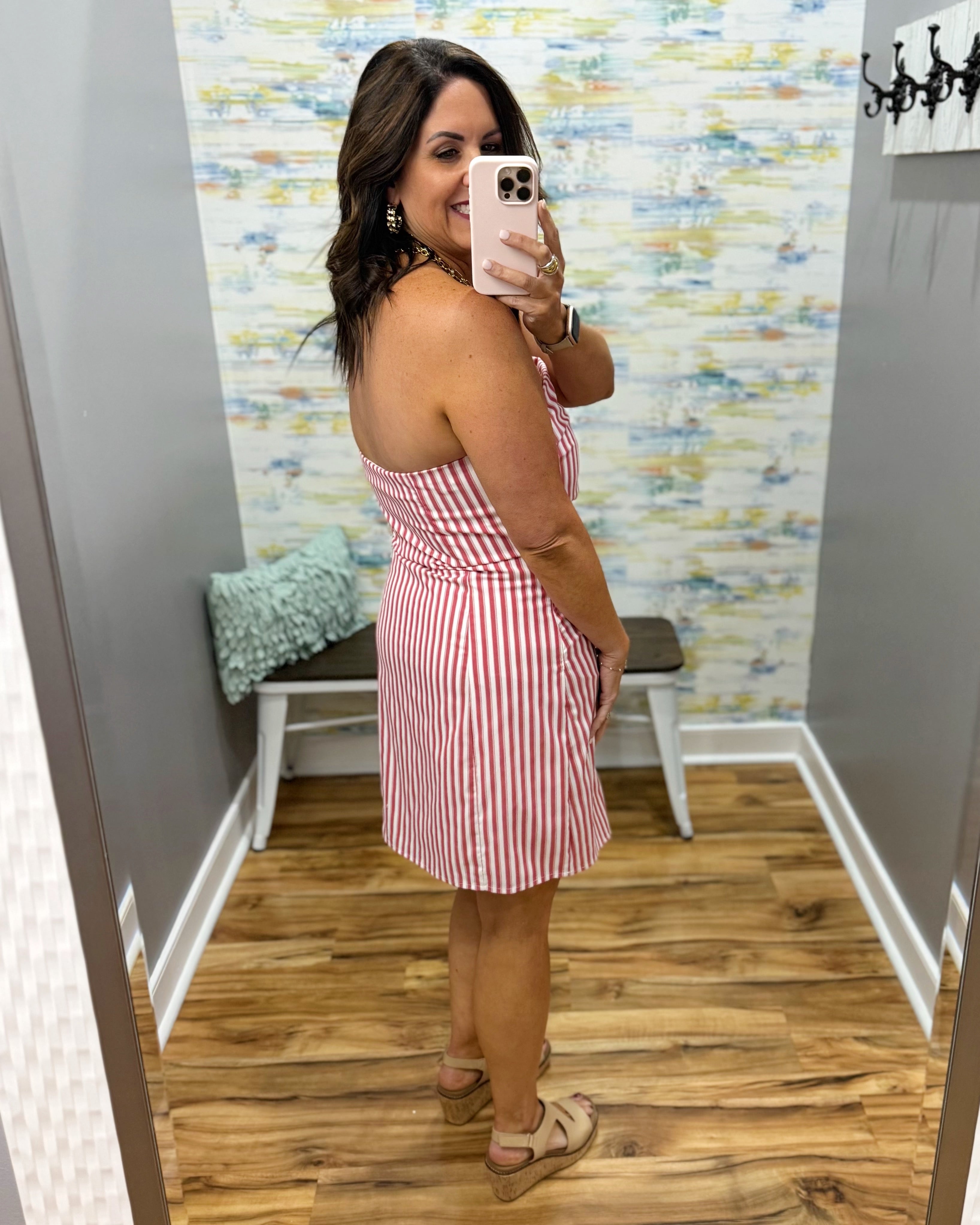 woman wearing a strapless red and white stripe dress.