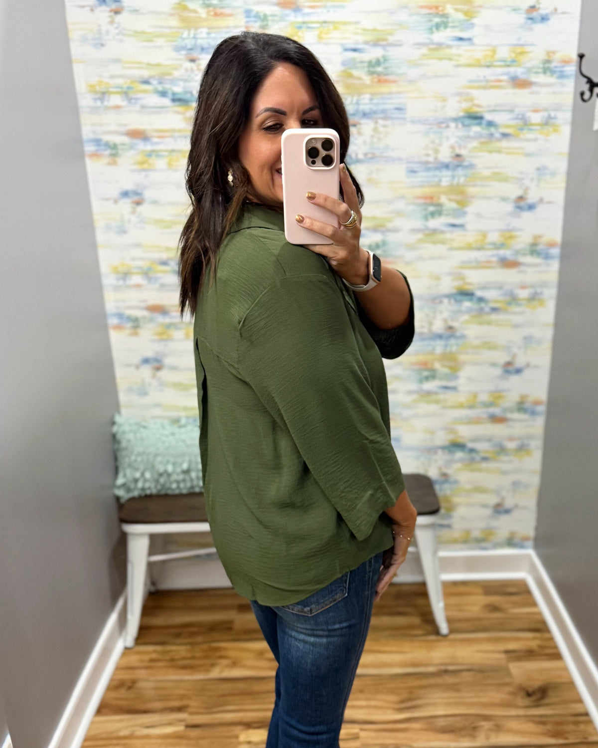 woman wearing a olive 3/4 sleeve flowy top.