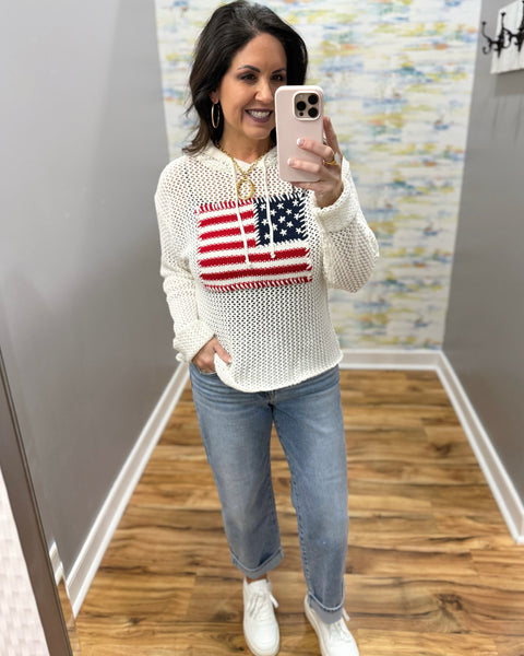 woman wearing american flag knit sweater in white