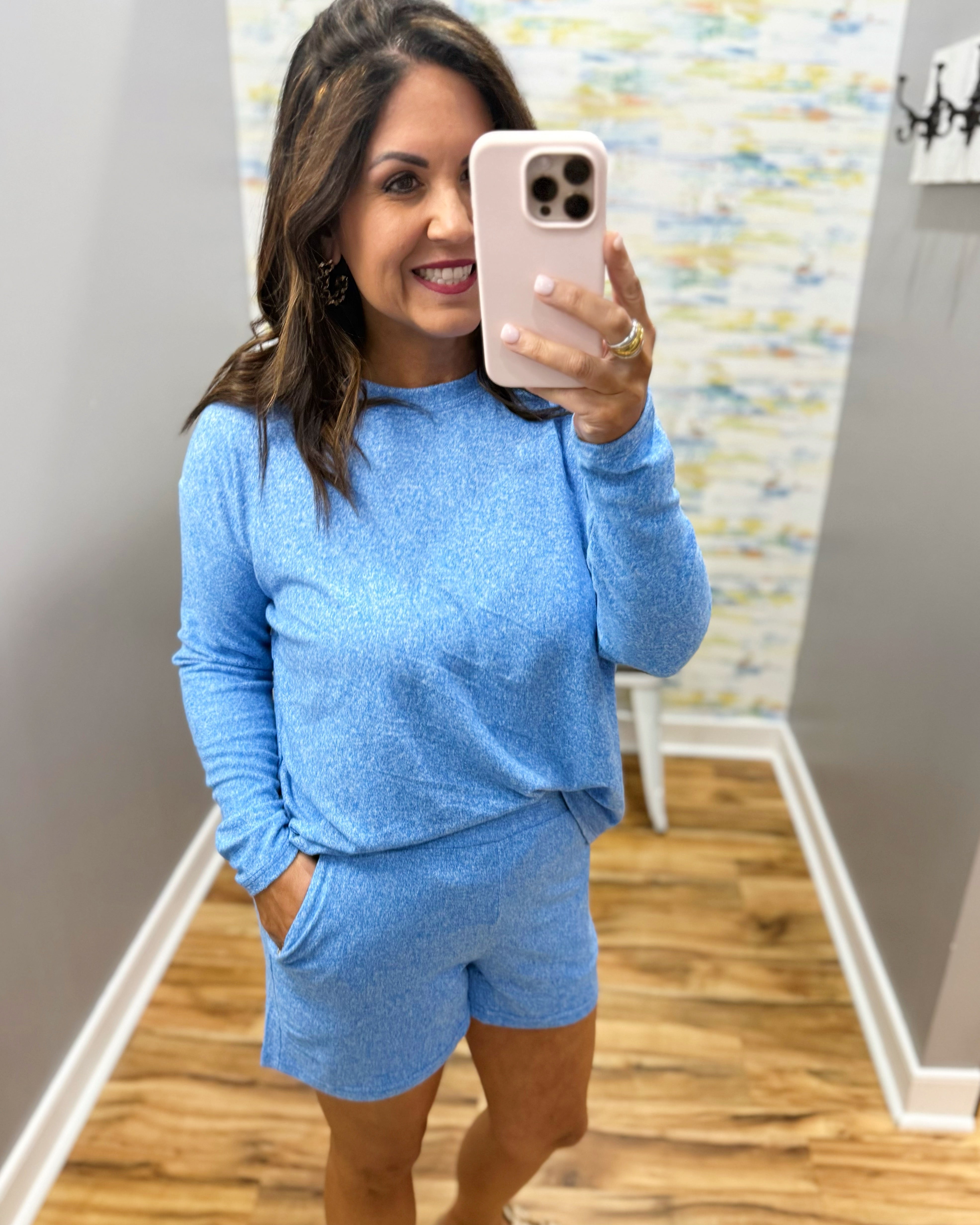 woman wearing blue lounge top and shorts set.