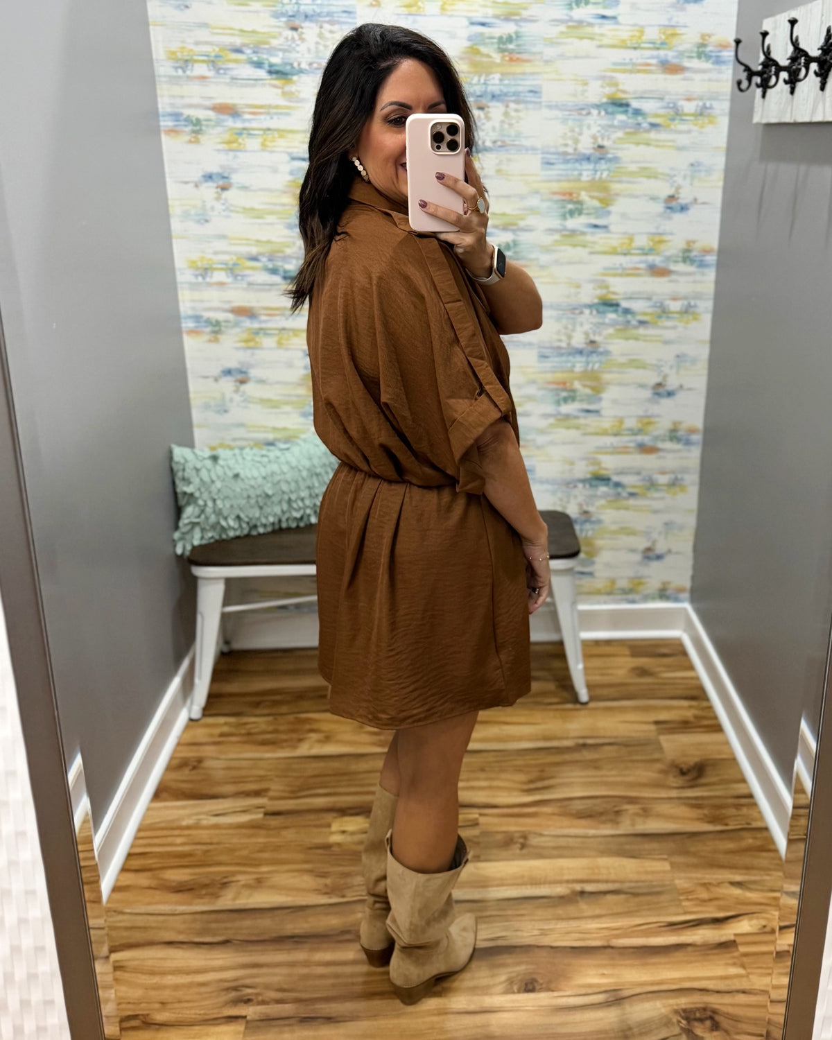 woman taking a selfie wearing a camel color wrap dress featuring a V-neckline, cinched waist, and flowy short sleeves for a feminine silhouette.