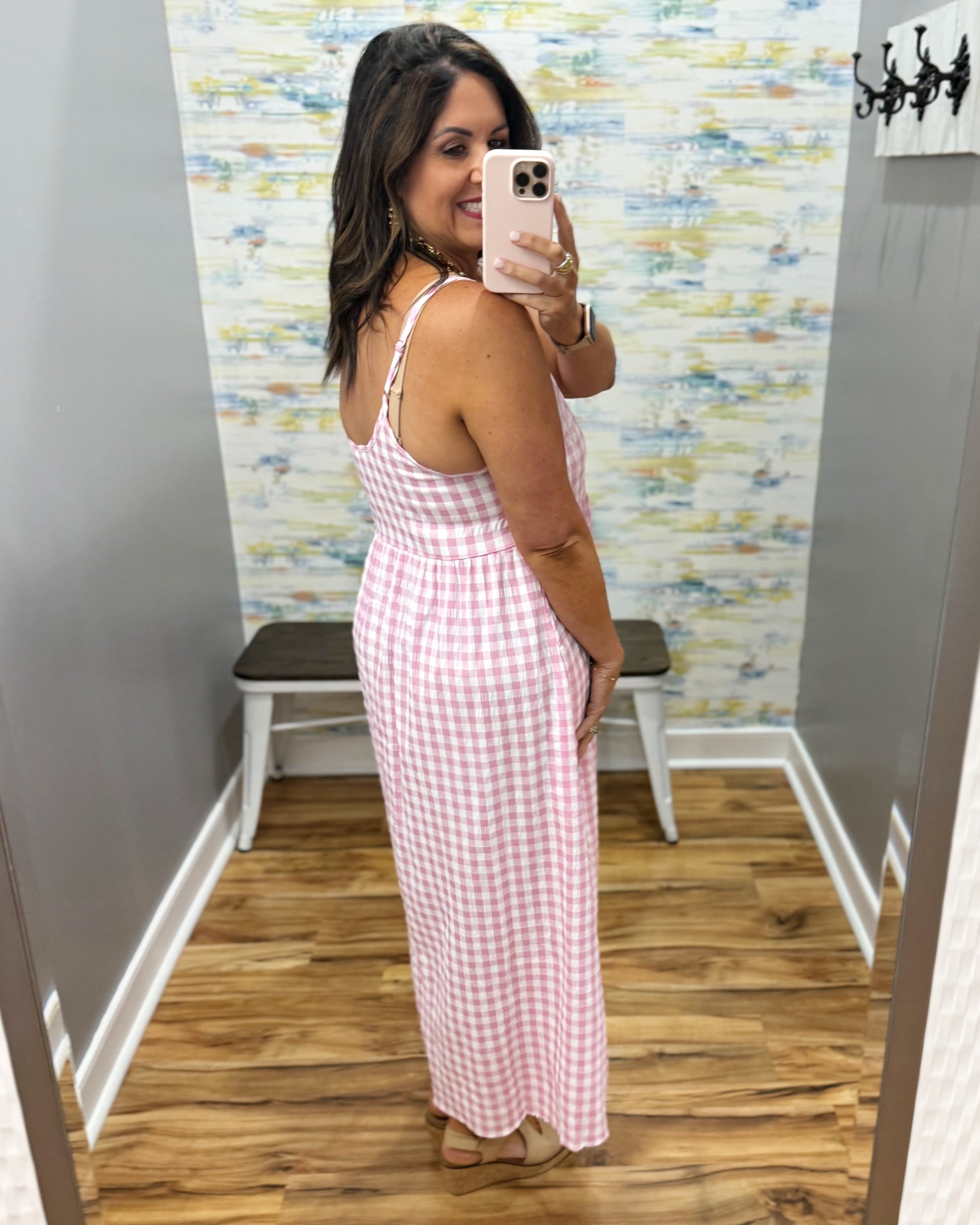 woman wearing gingham print dress in pink.