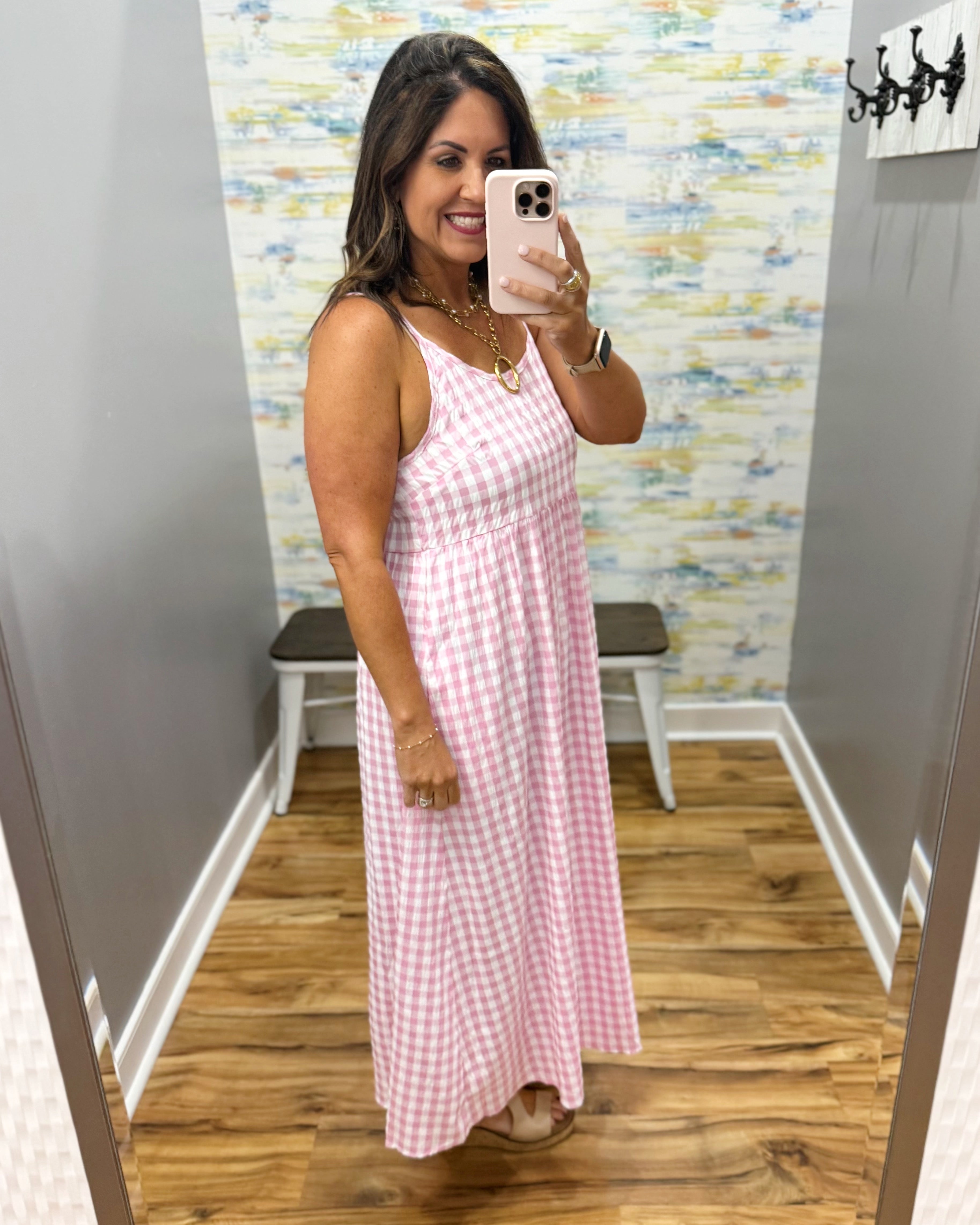 woman wearing gingham print dress in pink.