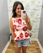 woman wearing a floral sweater tank. 