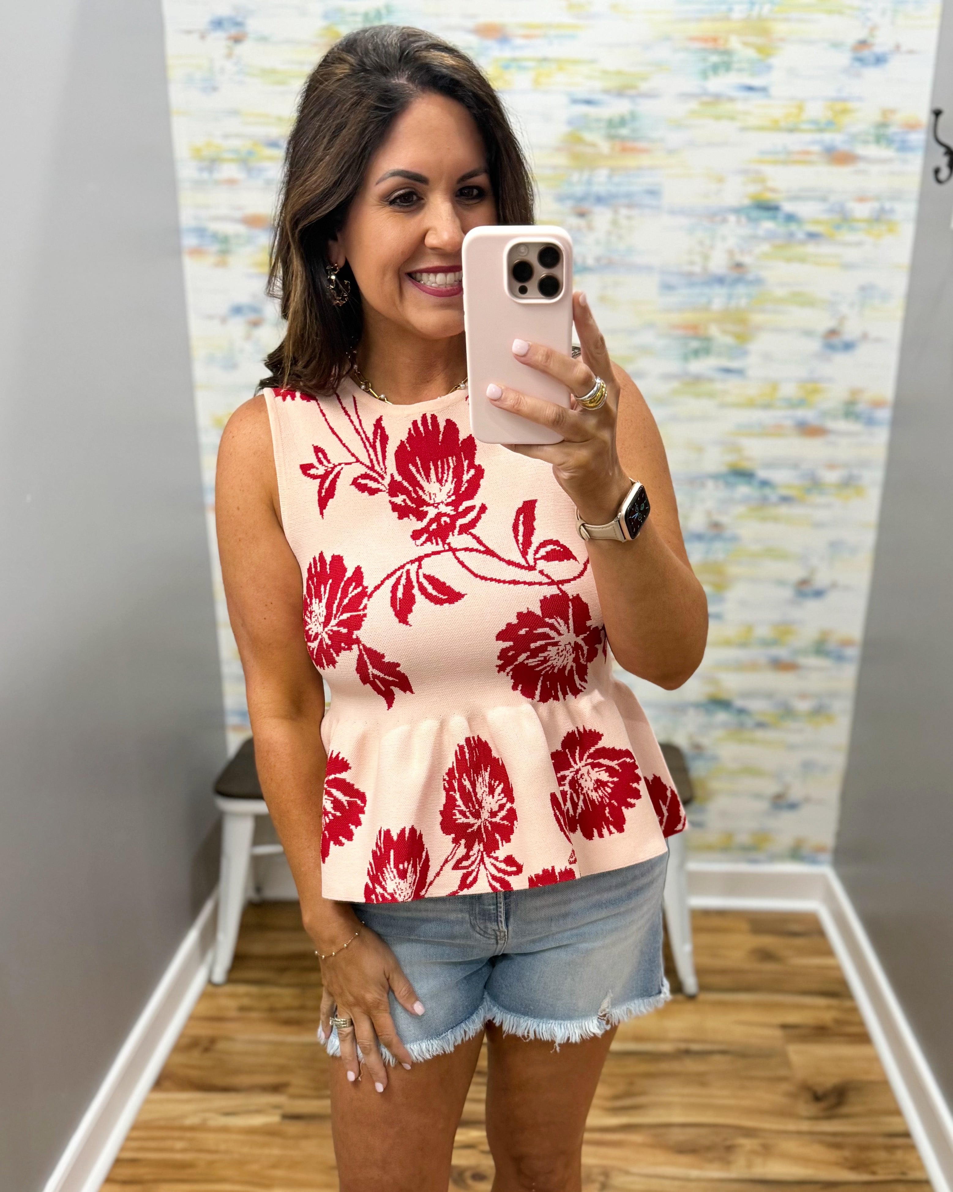 woman wearing a floral sweater tank. 