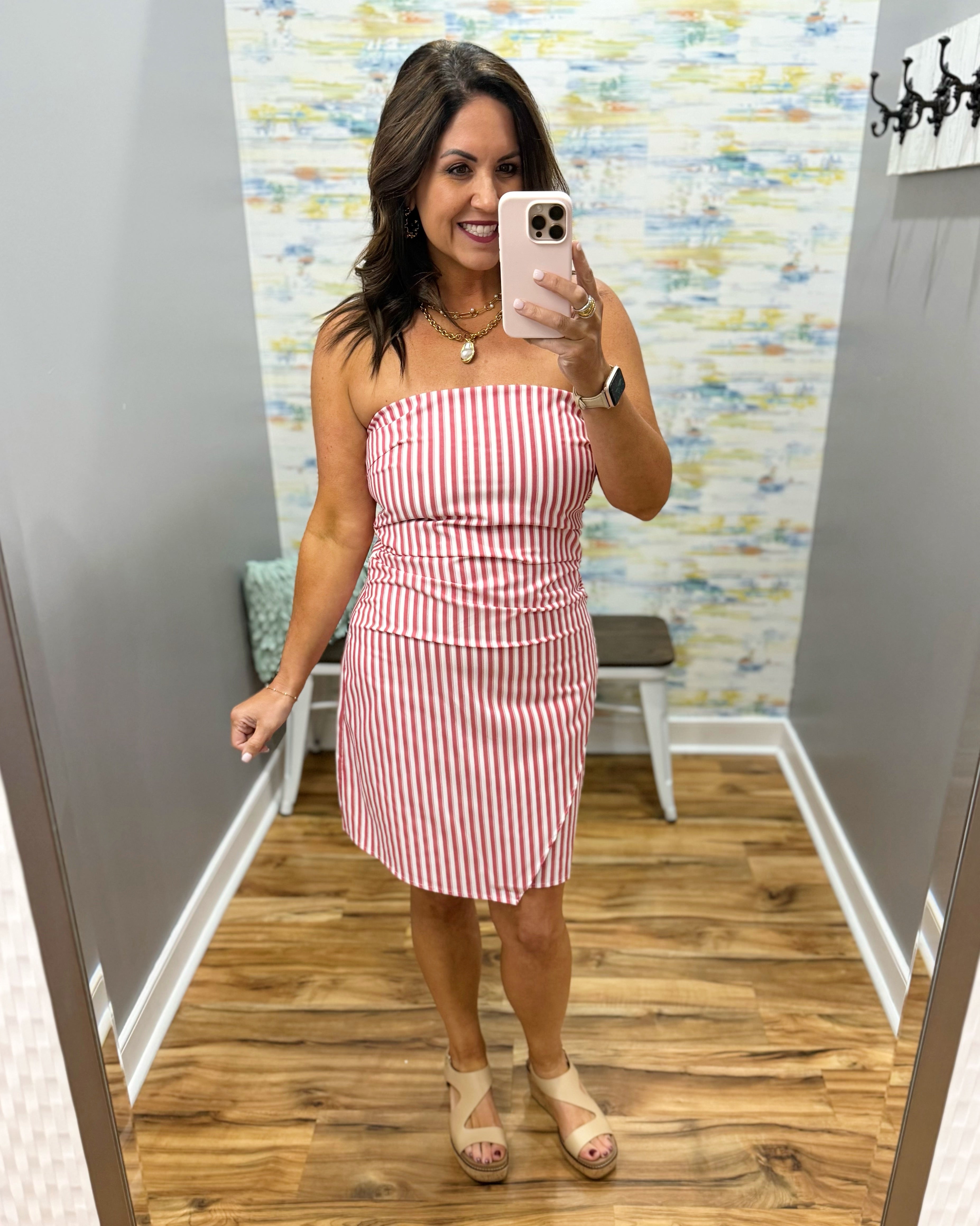 woman wearing a strapless red and white stripe dress.