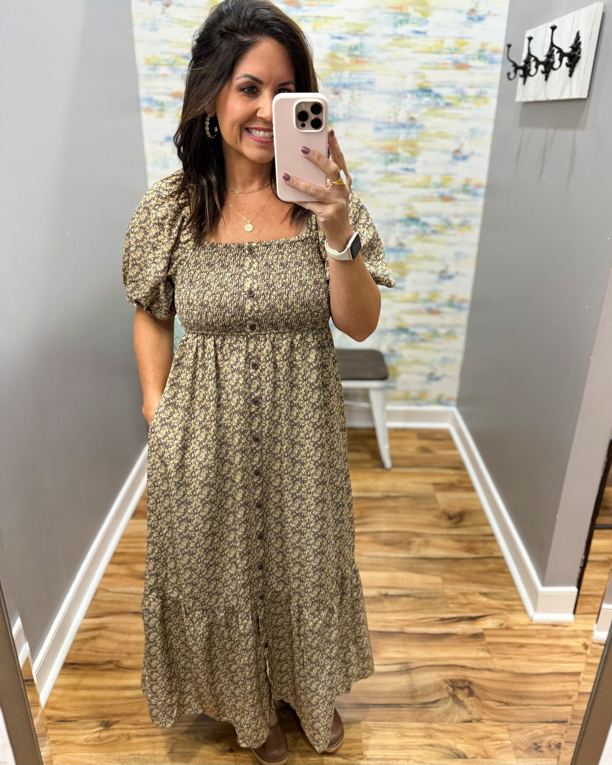woman taking a selfie wearing a floral midi dress features a pretty square neckline and smocked detailing for a comfortable, figure-flattering fit. Decorative non-functional buttons add a classic touch, while the midi length gives it an easy, polished silhouette.
