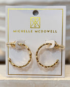 Gold hoop earrings on a branded card with 'Michelle McDowell' logo.