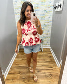 woman wearing a floral sweater tank. 