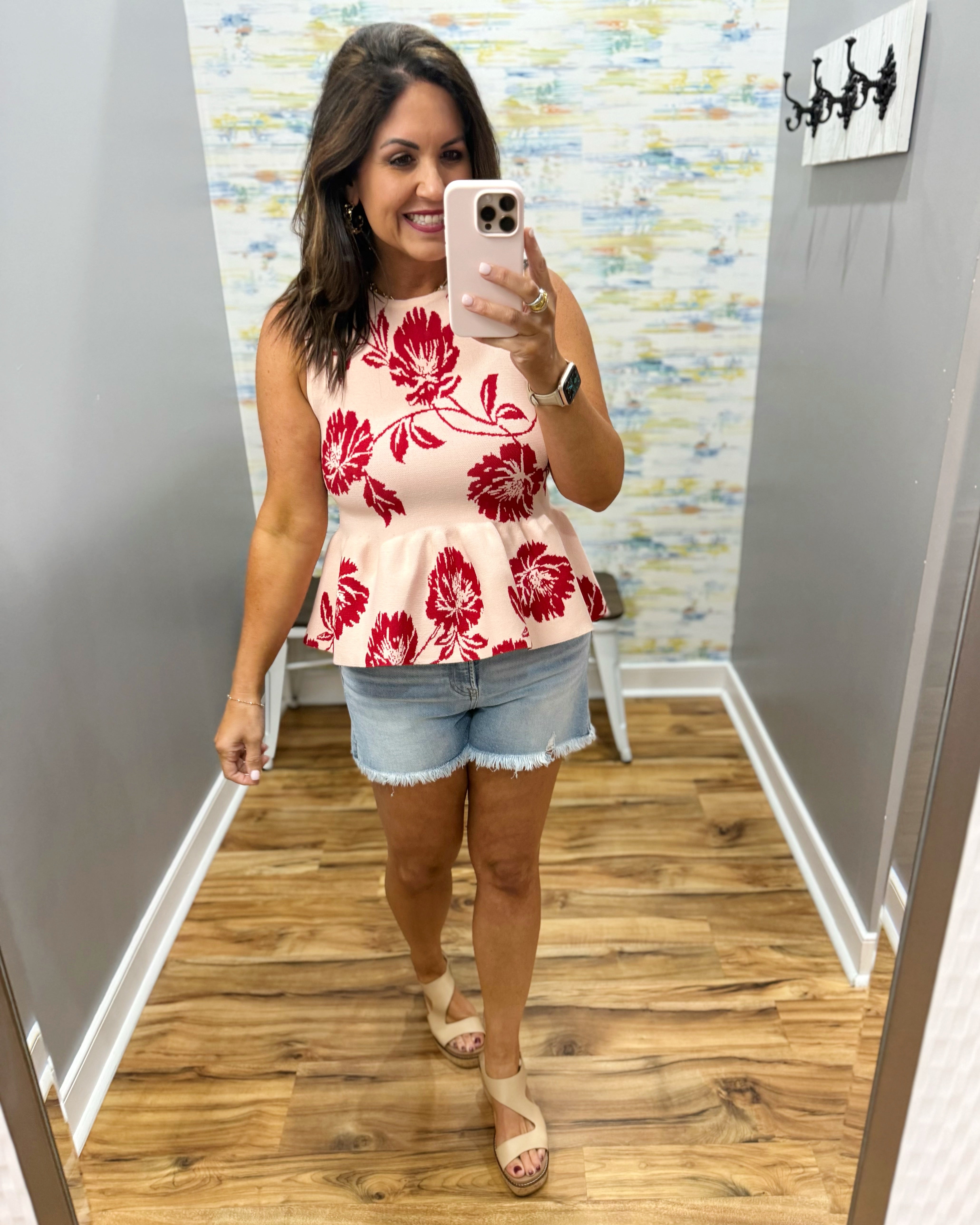 woman wearing a floral sweater tank. 