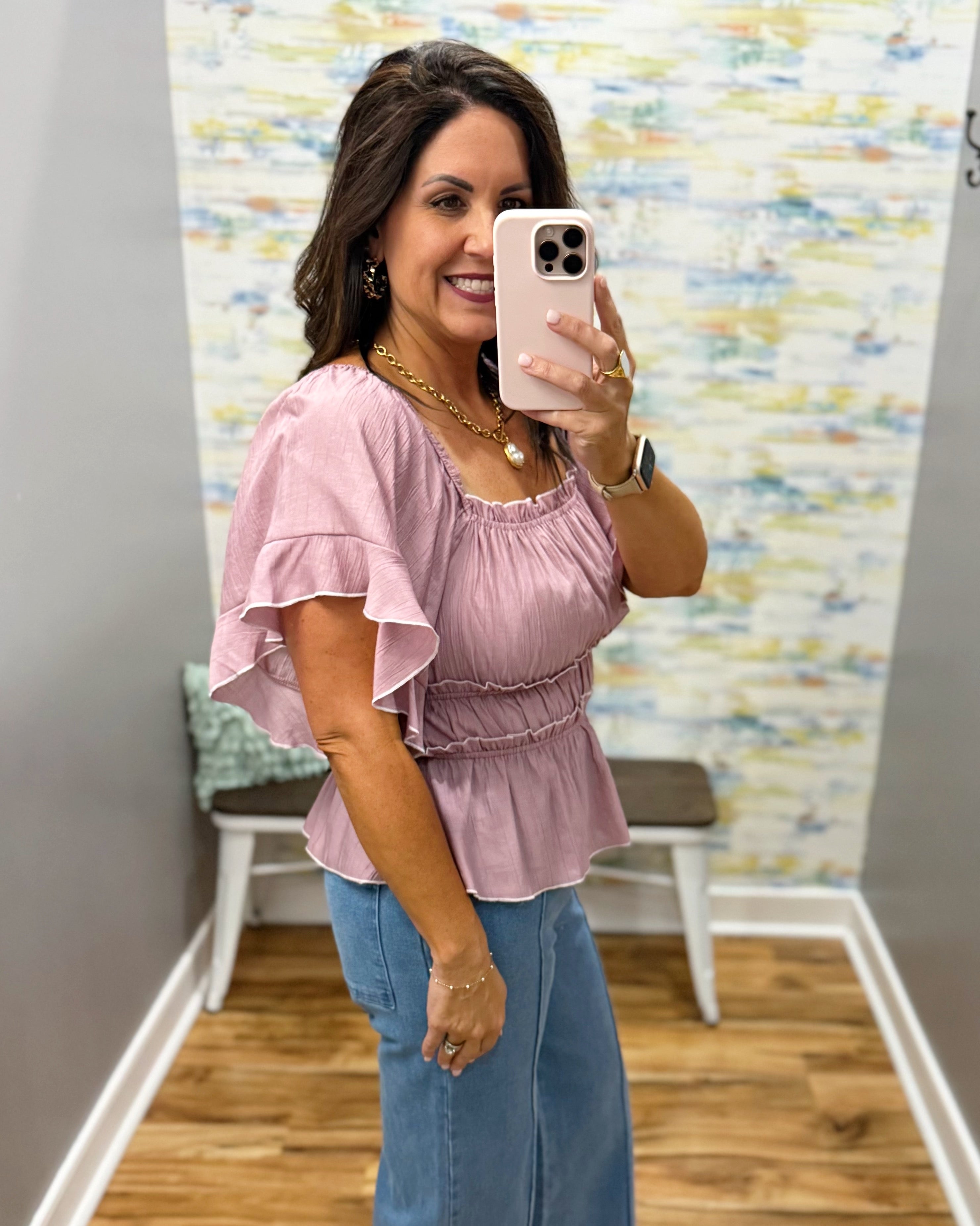 woman wearing a square neck top in mauve.