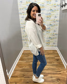 woman wearing a striped blouse in mocha and white